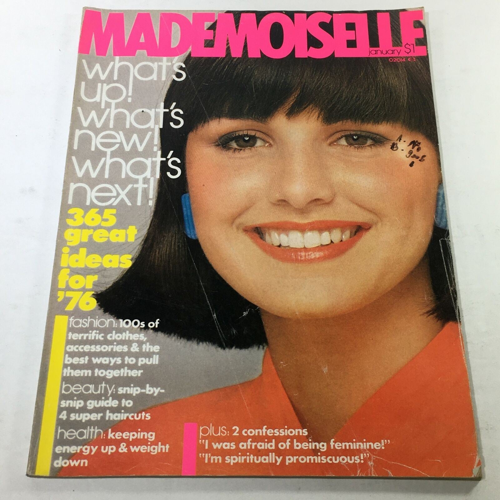 Cover of VTG Mademoiselle Magazine: January 1976 featuring a smiling woman with bold makeup, showcasing fashion trends from the mid-1970s.
