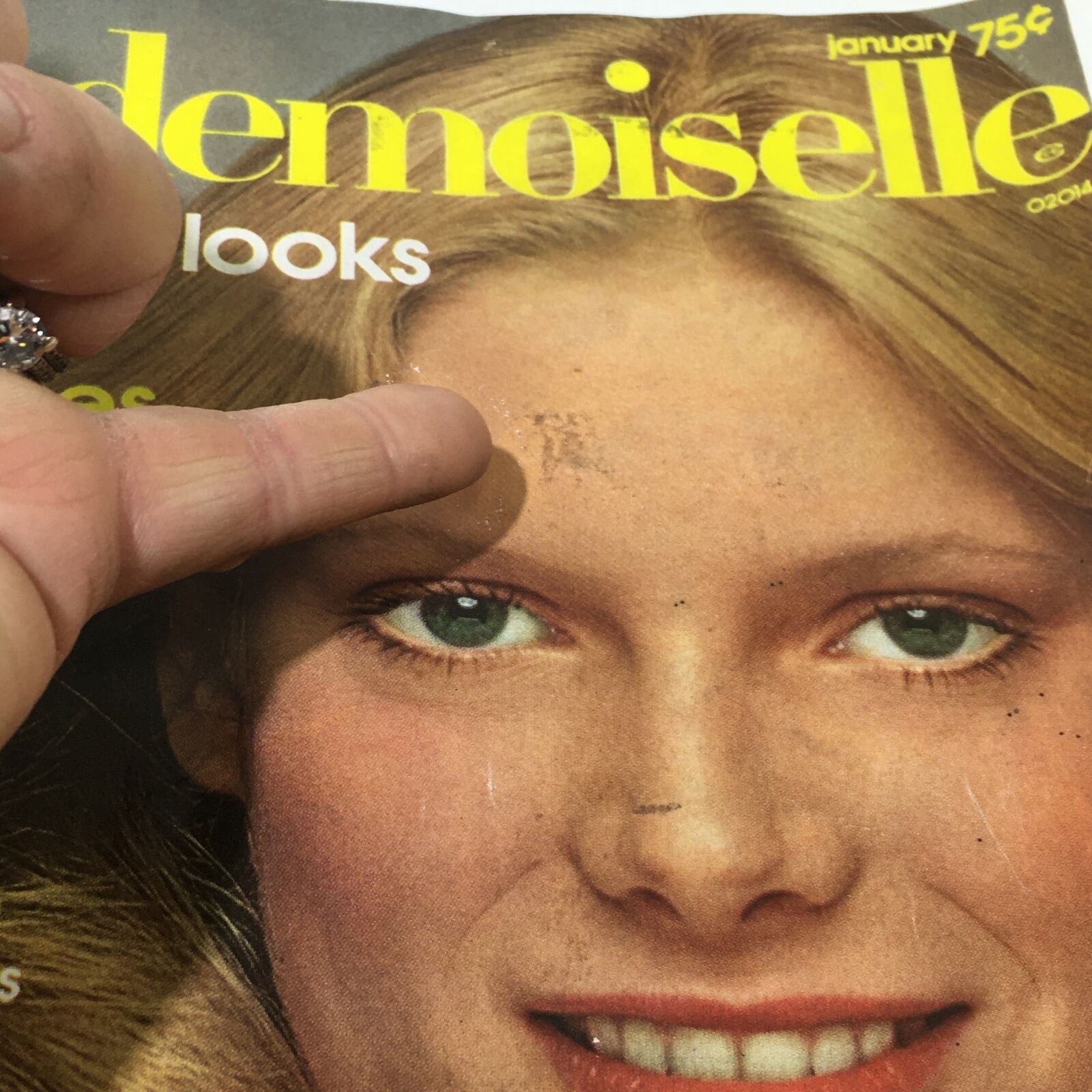 Close-up view of the Mademoiselle Magazine January 1975 cover with emphasis on the model's face and magazine title Great New Looks.