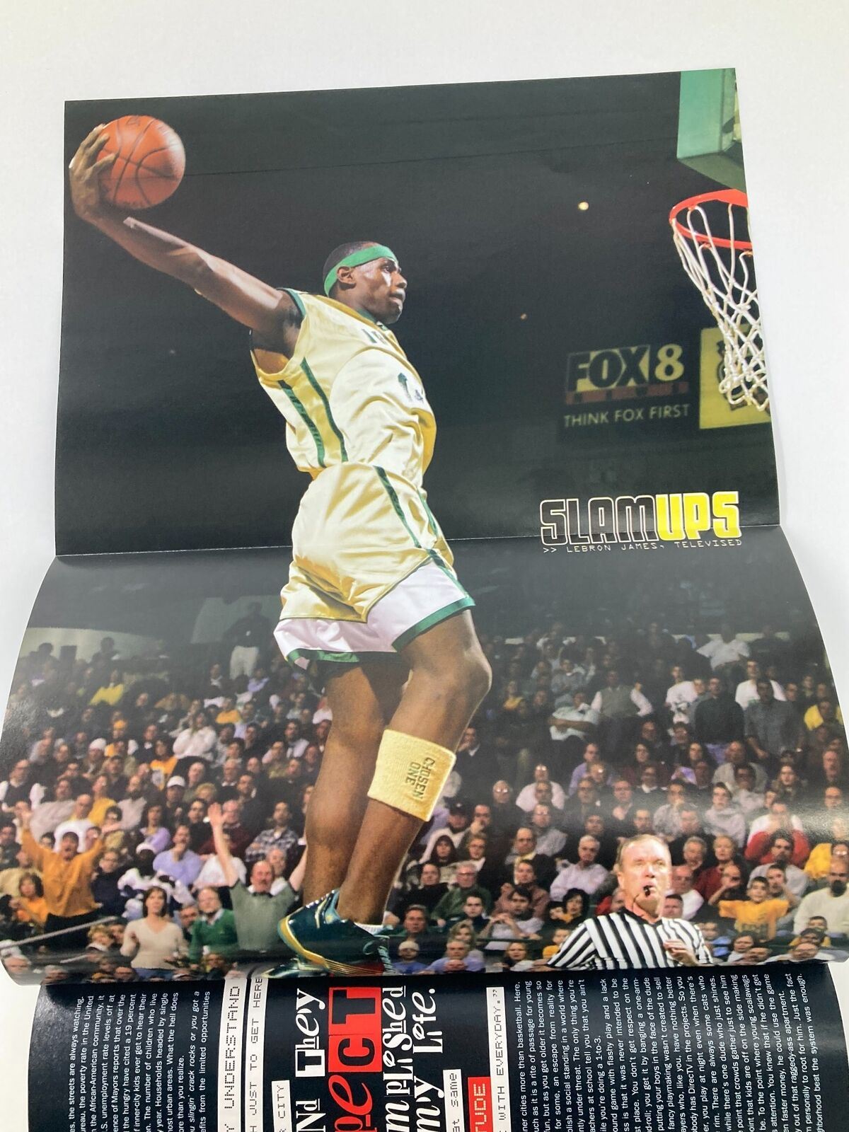 Slam Magazine April 2003 featuring a vibrant poster of an NBA player in mid-air dunk, celebrating the dynamic era of basketball, focused on Allen Iverson.