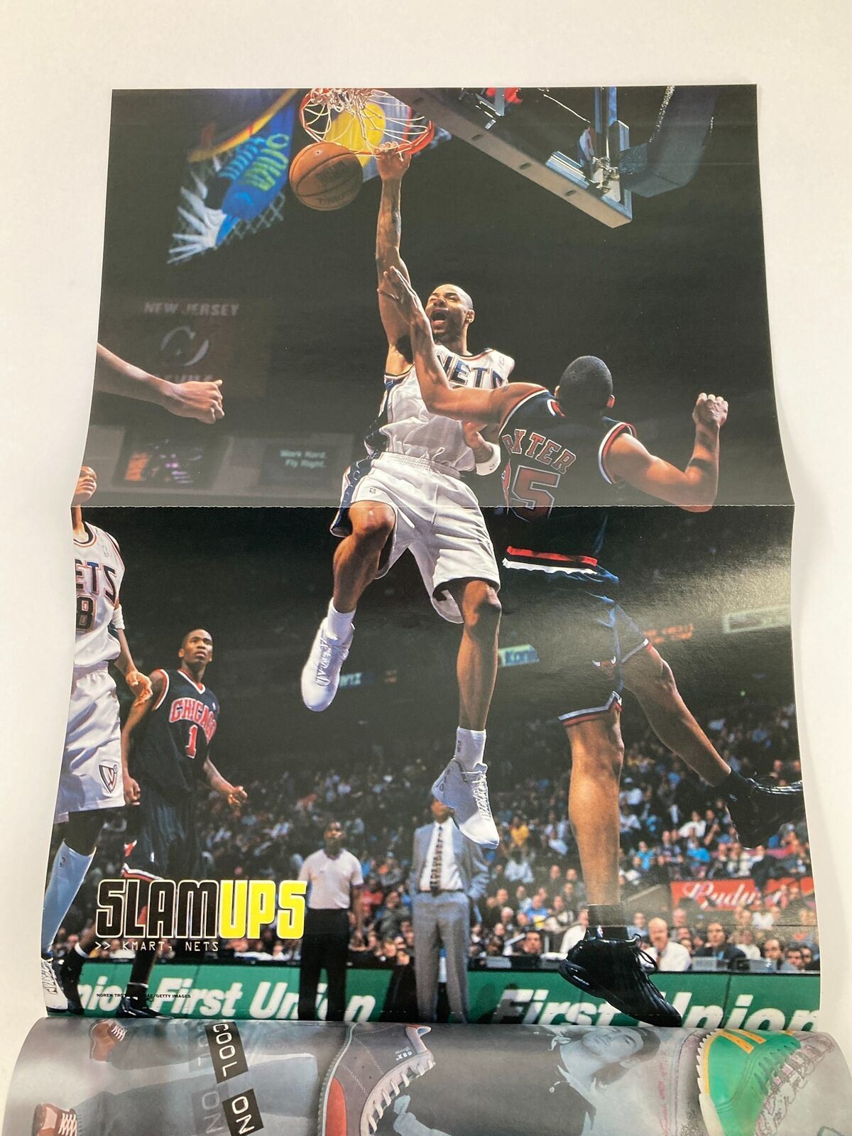 Slam Magazine April 2003 showcasing another stunning poster of an NBA player executing a high-flying dunk, emphasizing the thrilling moments captured in this vintage magazine.