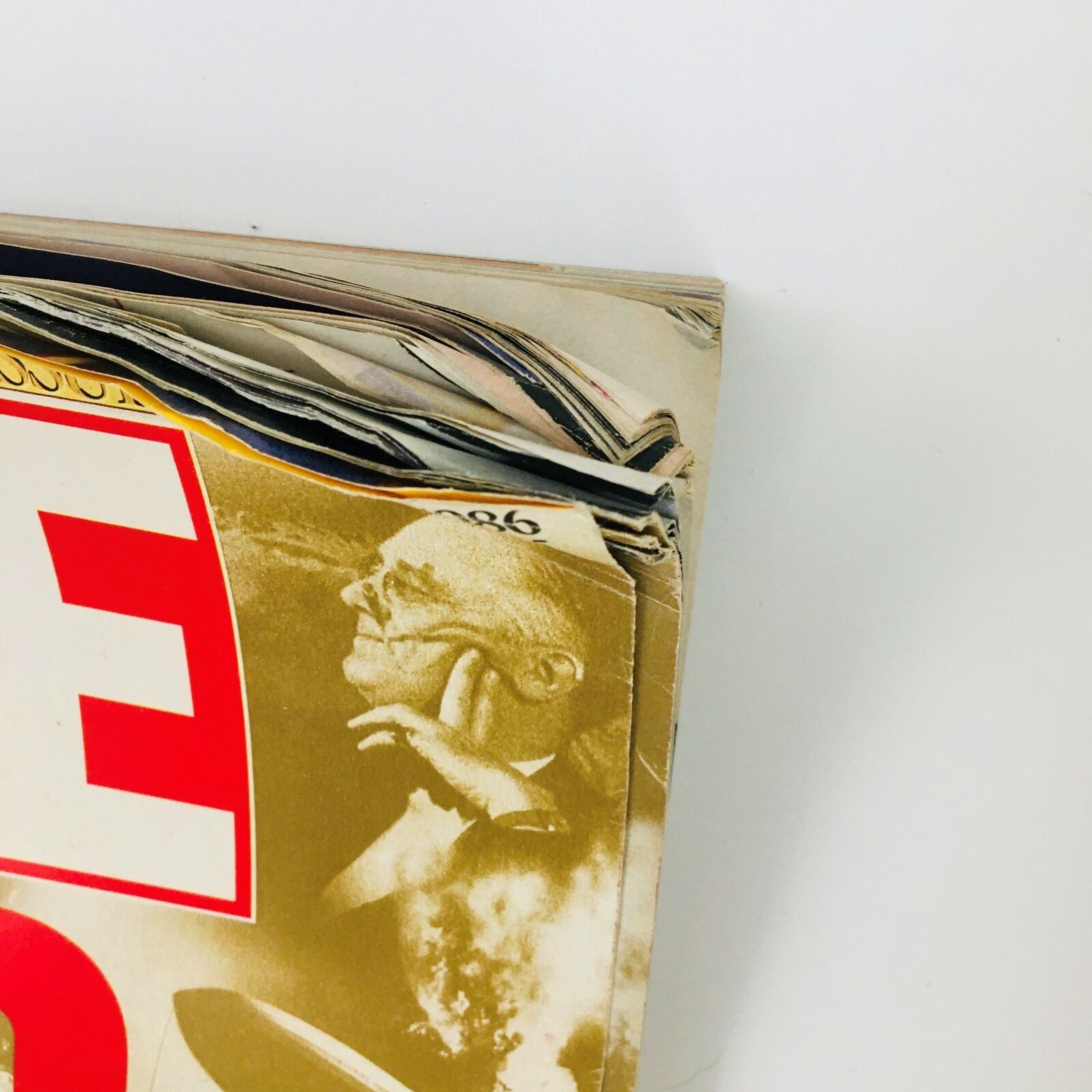 Close-up view of the edge of VTG Life Magazine Fall 1986 featuring Muhammad Ali and Kennedy, highlighting the magazine's wear and vintage condition.