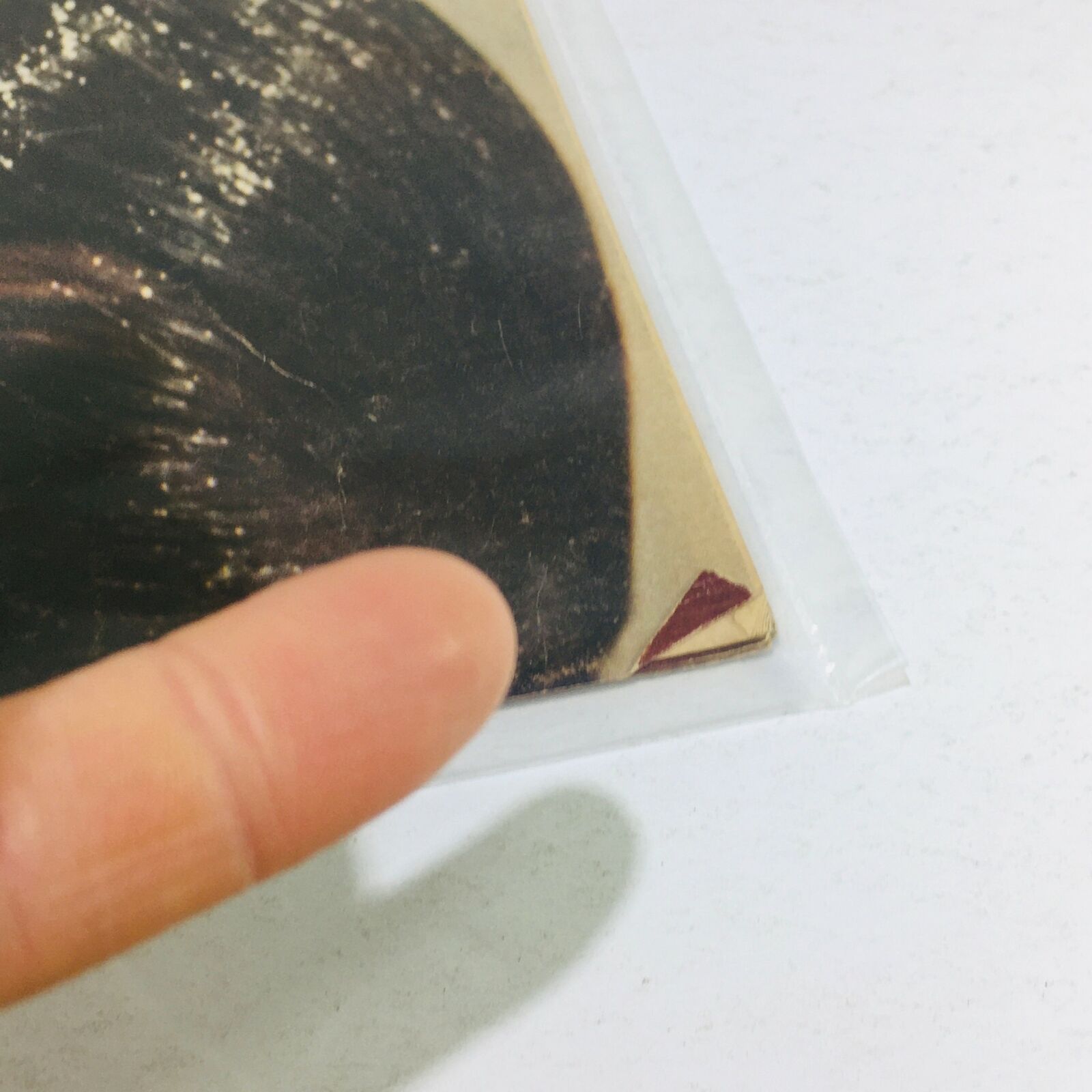 Close-up view of the corner of the VTG Life Magazine from August 18, 1972, showcasing the wear on the cover with a finger pointing at a red triangular image detail related to the preview of the Munich Surge to the Olympics.