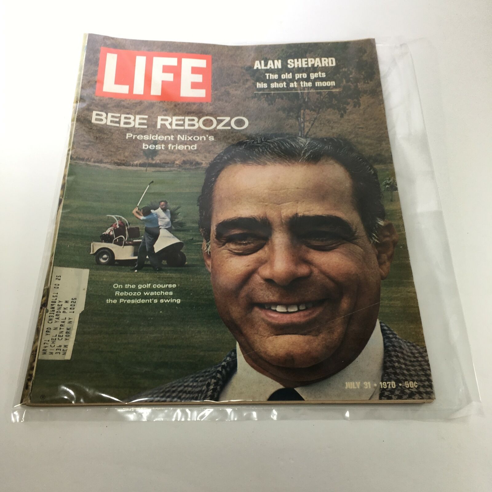 July 31, 1970 issue of Life Magazine featuring Bebe Rebozo on the cover, showcasing an image of him smiling alongside a golf course where he watches President Nixon's swing, detailed with magazine text and historical context.