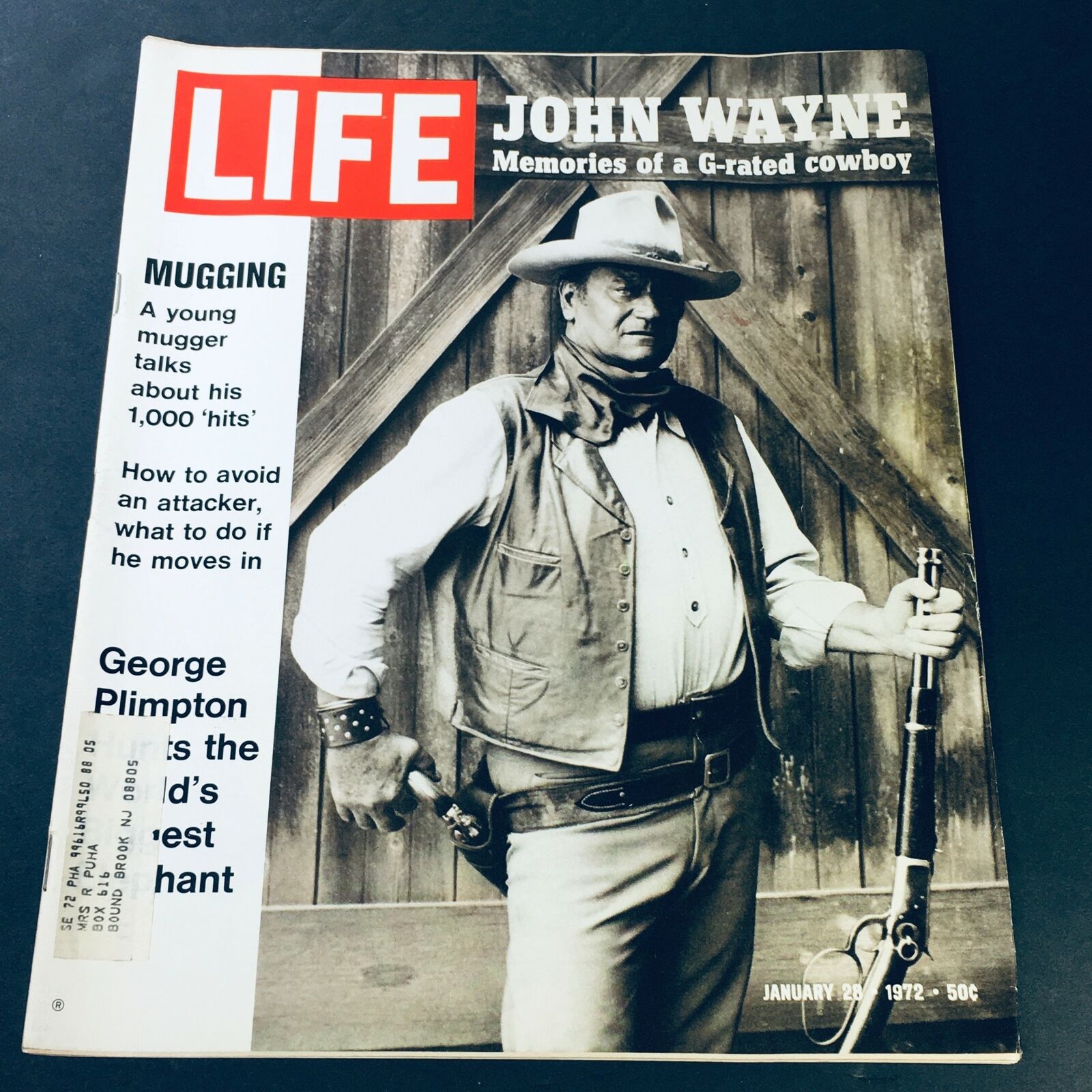 Cover of VTG Life Magazine January 28, 1972 featuring George Plimpton and the article 'A Young Mugger Talks', showcasing a black and white image of a cowboy holding a rifle, evoking themes of urban life and social commentary.