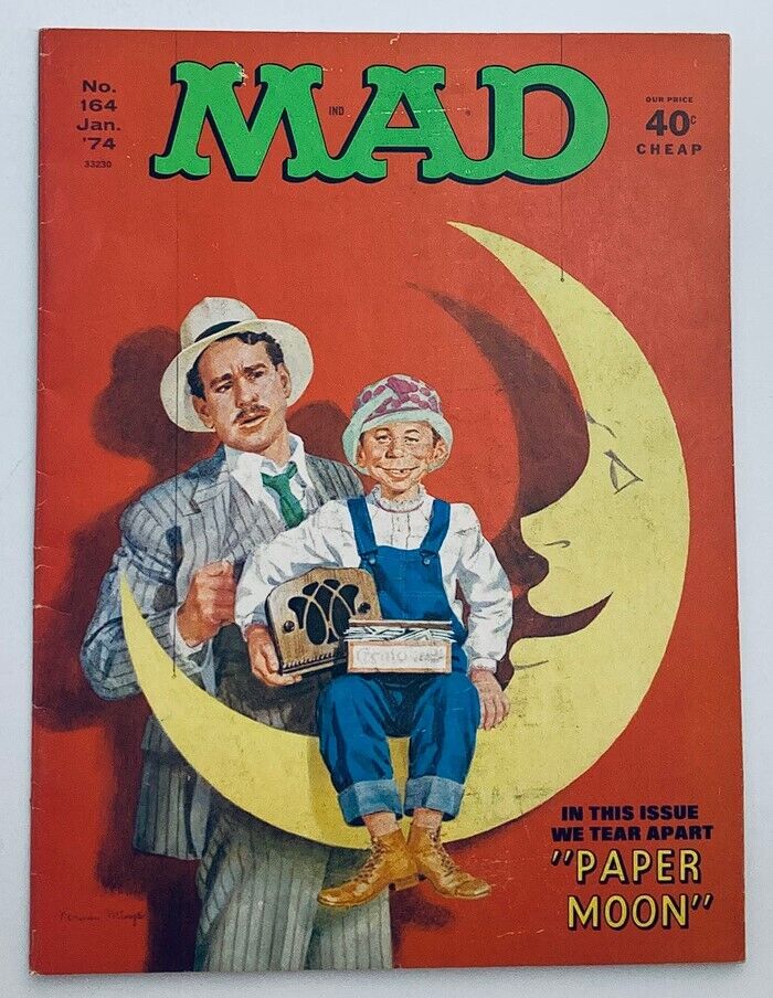 Cover of Mad Magazine January 1974 No. 164 featuring a humorous illustration related to the issue's theme 'We Tear Apart Paper Moon'. The image depicts two characters, one in a suit and the other in overalls, sitting on a large crescent moon against a vibrant orange background.