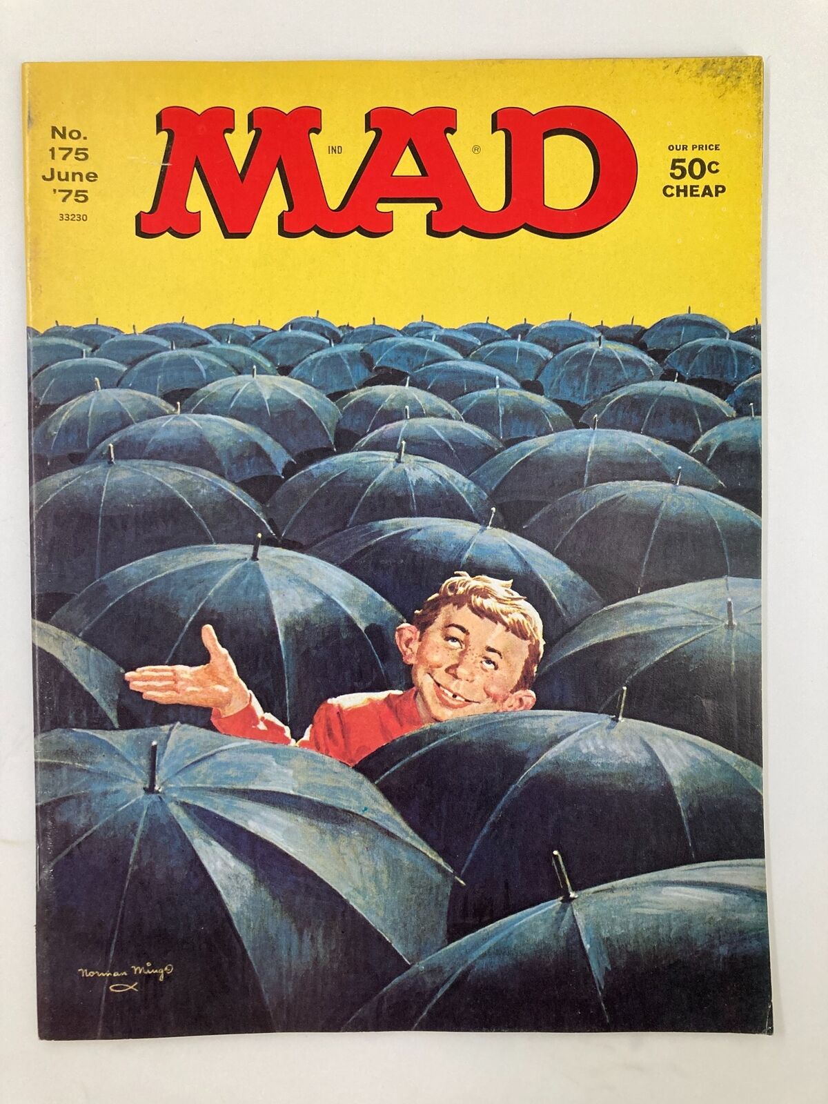 Cover of Mad Magazine June 1975 No. 175 featuring a young boy amidst a sea of blue umbrellas, showcasing the magazine's signature humor and vibrant artwork.