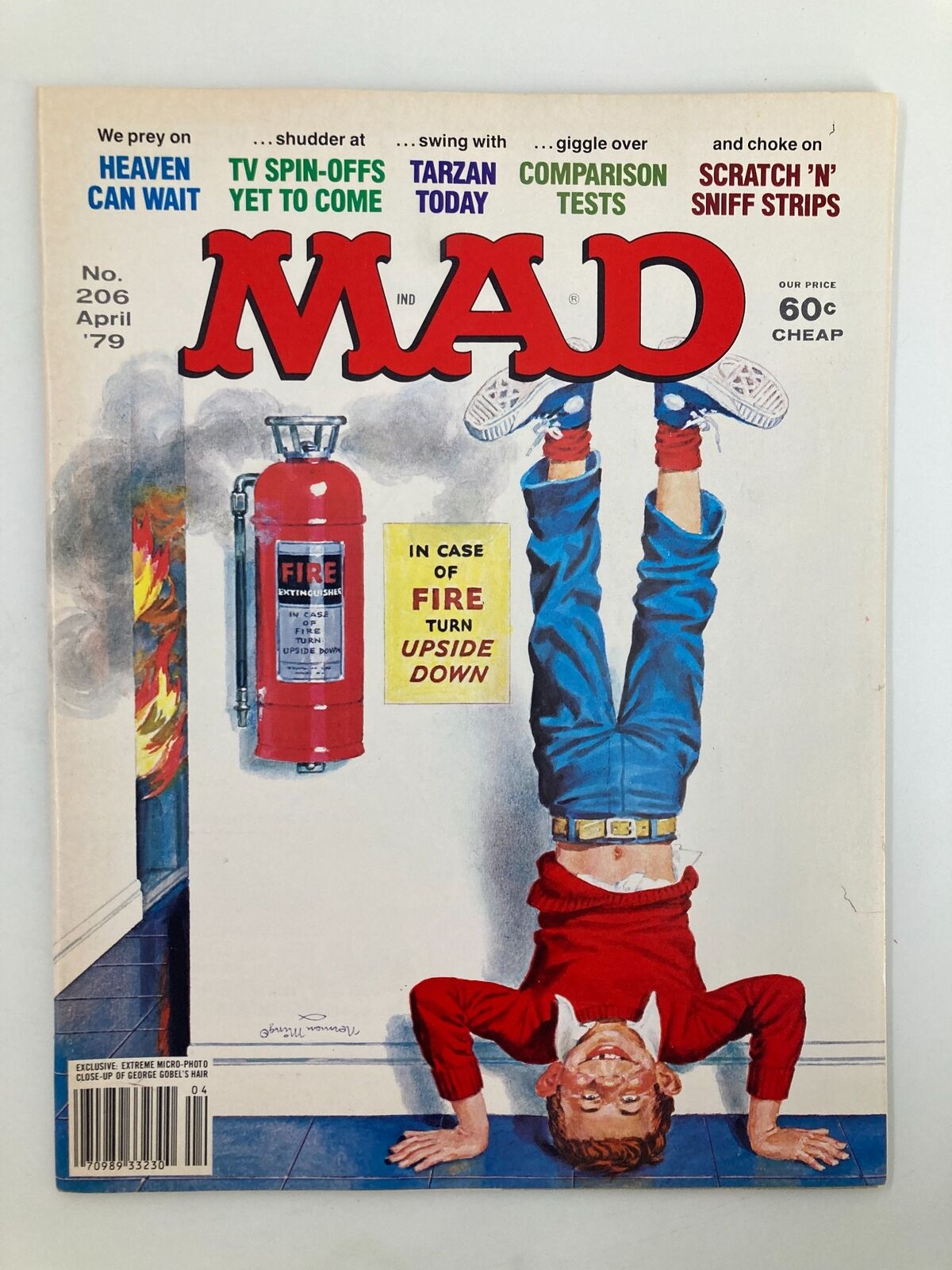 Mad Magazine April 1979 No. 206 cover featuring a humorous illustration of a boy standing on his hands in a playful pose, with a fire extinguisher and text advising to 'turn upside down'.