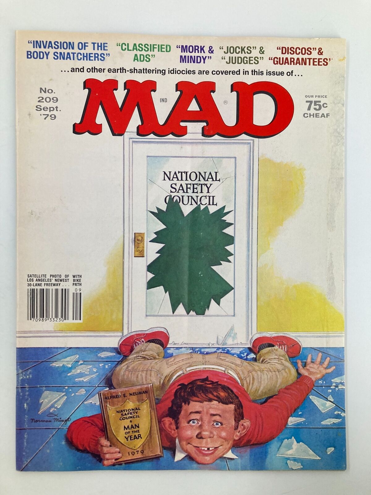 Cover of Mad Magazine September 1979 No. 209 featuring the National Safety theme, showcasing iconic humor and illustrations with Alfred E. Neuman holding an award on a shattered glass floor.