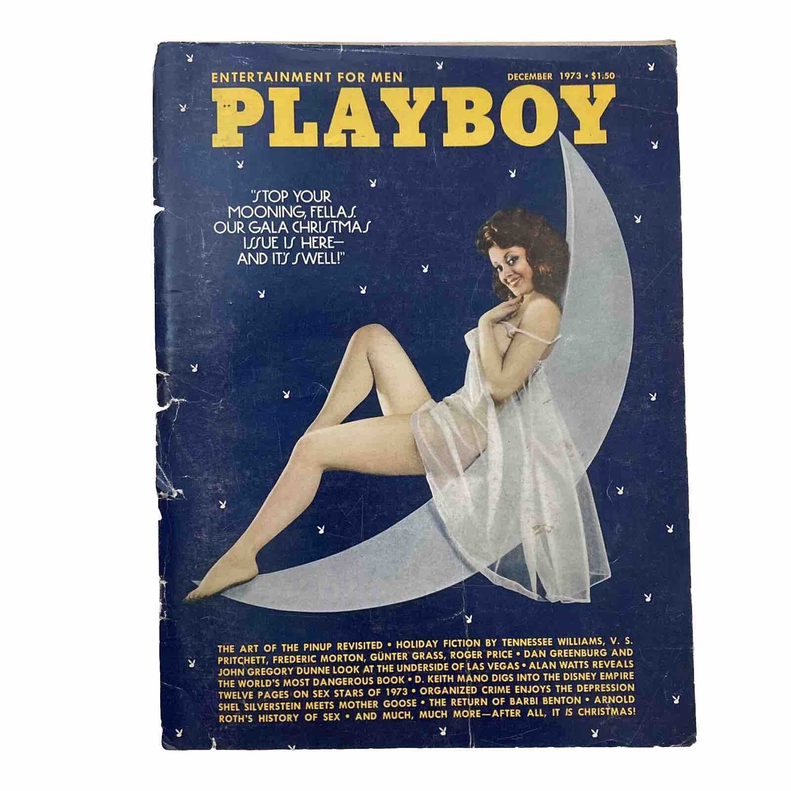 Vintage Playboy Magazine December 1973 cover featuring a model in a white outfit against a moon backdrop, highlighting the iconic design of the era.