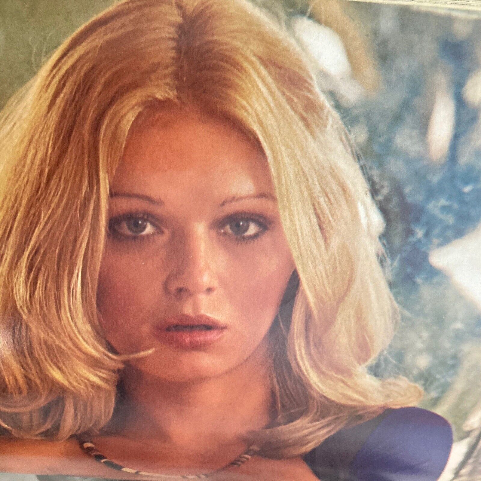 Centerfold image from the Vintage Playboy Magazine December 1973, focusing on a blonde model with a captivating expression, illustrating the allure of the era.