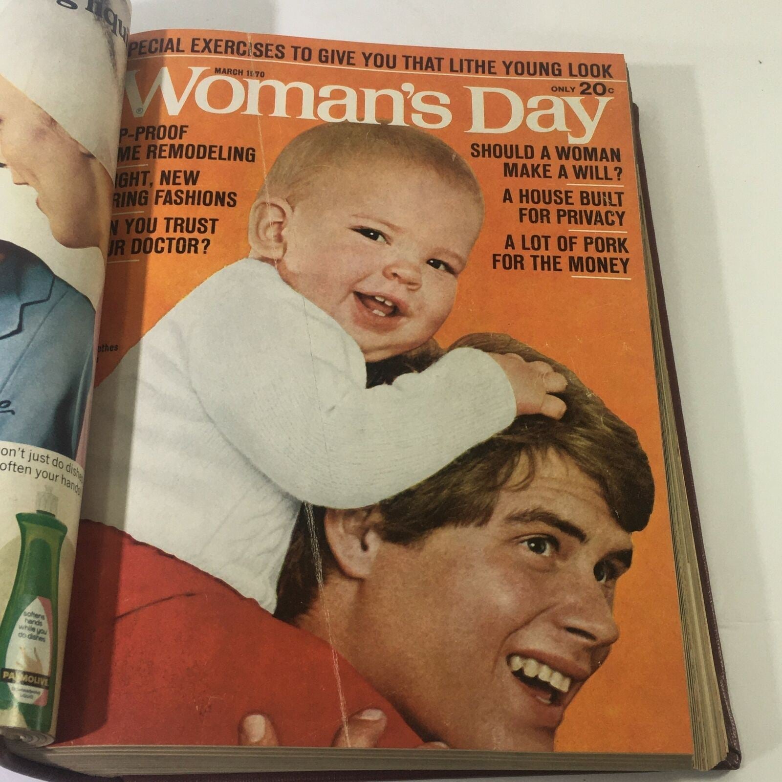 Cover of 1970 Woman's Day Magazine featuring a smiling baby on the shoulder of a man, promoting parenting and family topics.