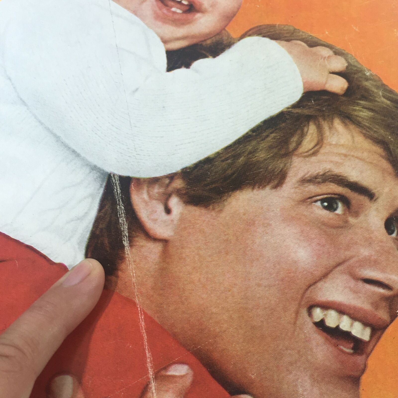 Close-up of the 1970 Woman's Day Magazine cover, highlighting a happy baby and a young man's smile, emphasizing themes of family.
