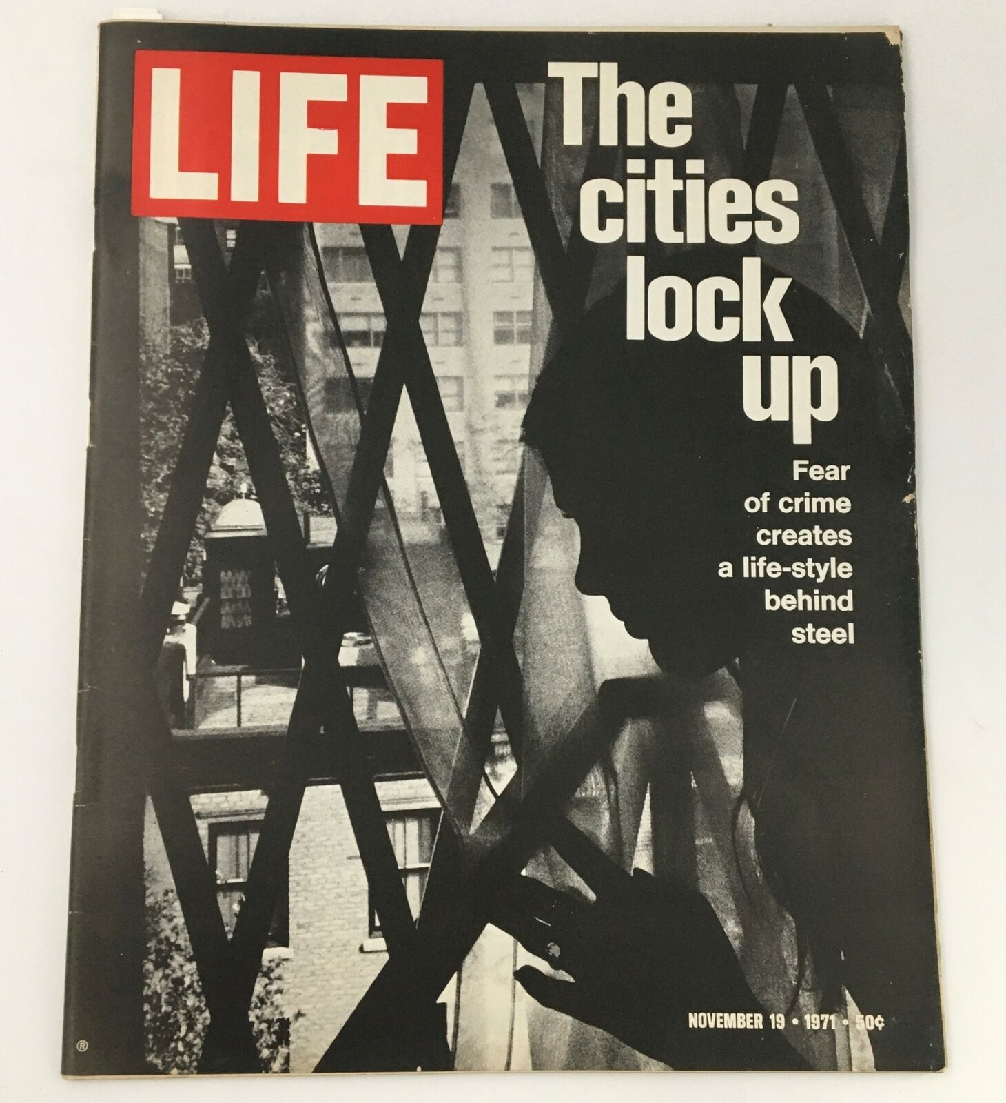 VTG Life Magazine November 19 1971 cover featuring 'The Cities Lock Up' article, showcasing a silhouette of a woman behind a window with security bars, reflecting concerns about urban safety.