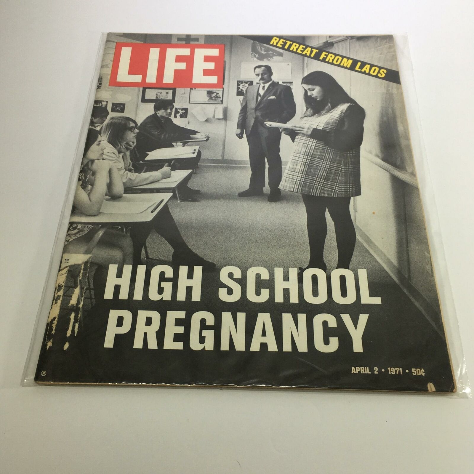 Cover of Life Magazine dated April 2, 1971, featuring the topics 'Retreat from Laos' and 'High School Pregnancy' with an image of students in a classroom setting.