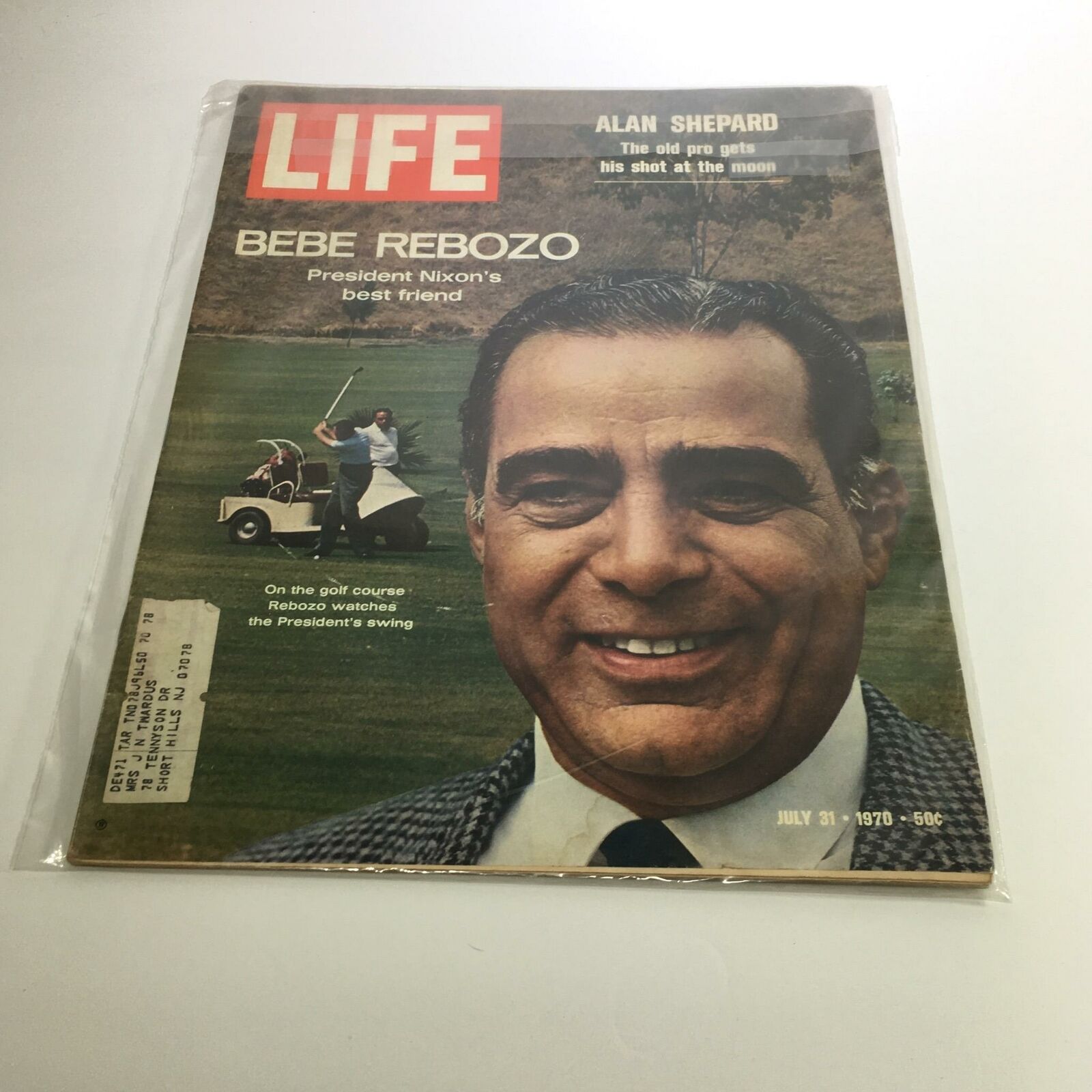 Cover of Life Magazine from July 31, 1970 featuring Bebe Rebozo, President Nixon's best friend, smiling while watching a golfer, showcasing a significant moment in American history.