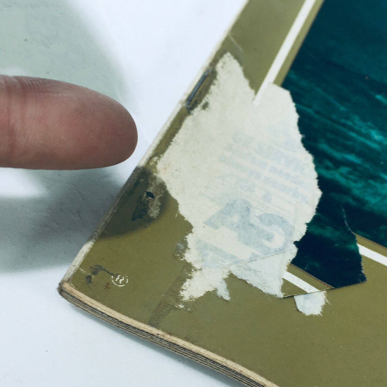 Close-up of the edge of the July 9, 1971, Vintage Life Magazine cover showing wear and a torn area, highlighting its authentic vintage condition, with address label remnants.