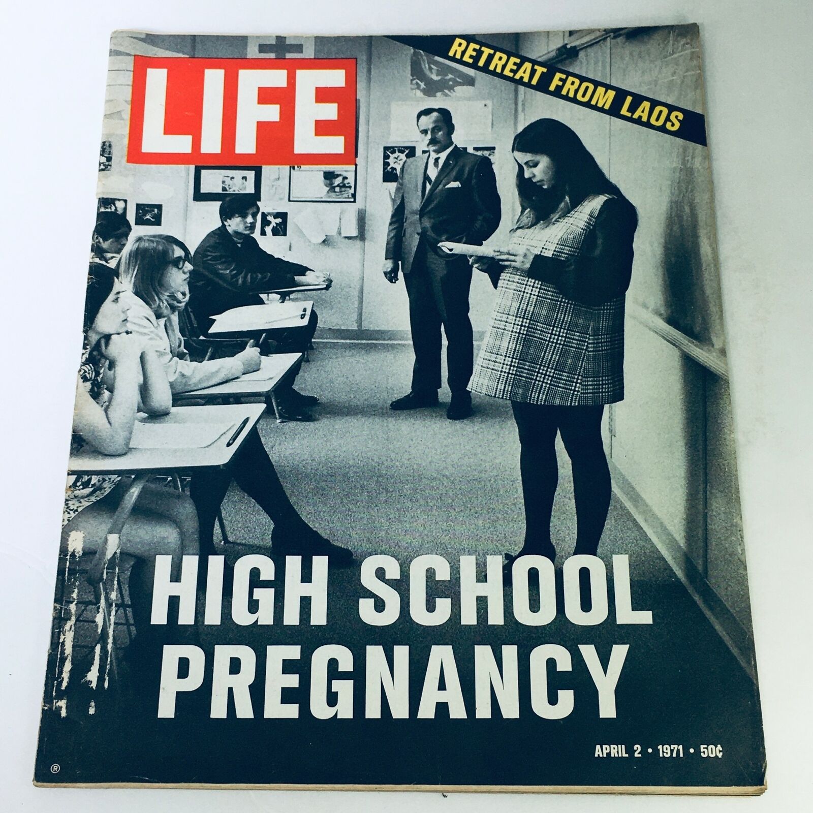 Cover of the Vintage Life Magazine from April 2, 1971, featuring a high school classroom scene. The headline highlights 'High School Pregnancy' and 'Retreat From Laos', showcasing the societal issues of the early 70s.