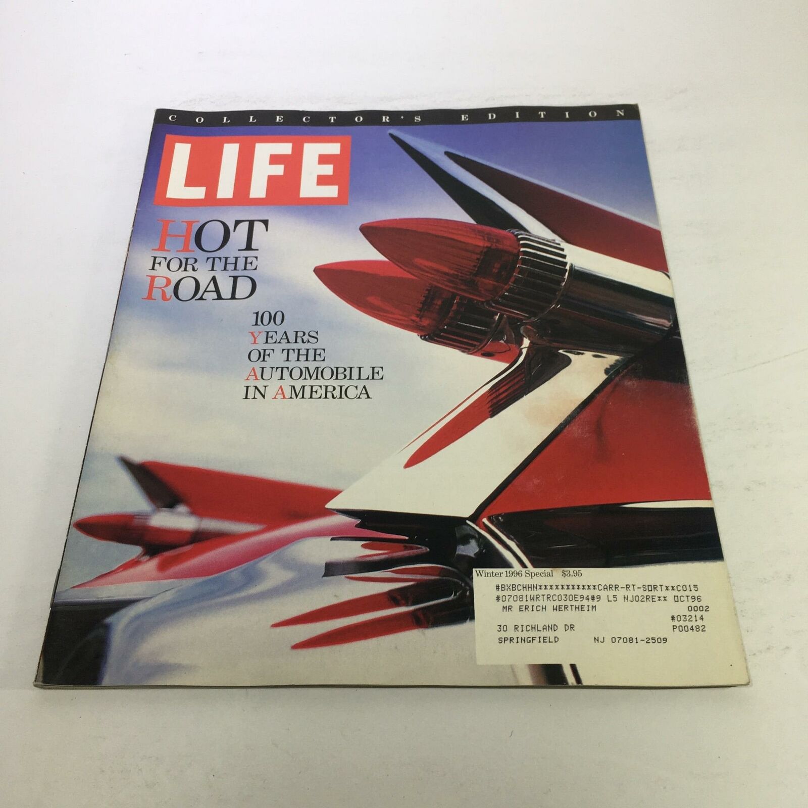 Cover of Life Magazine Winter 1996 Special titled '100 Years of the Automobile in America', featuring a striking image of classic automobile tail lights against a vibrant background.