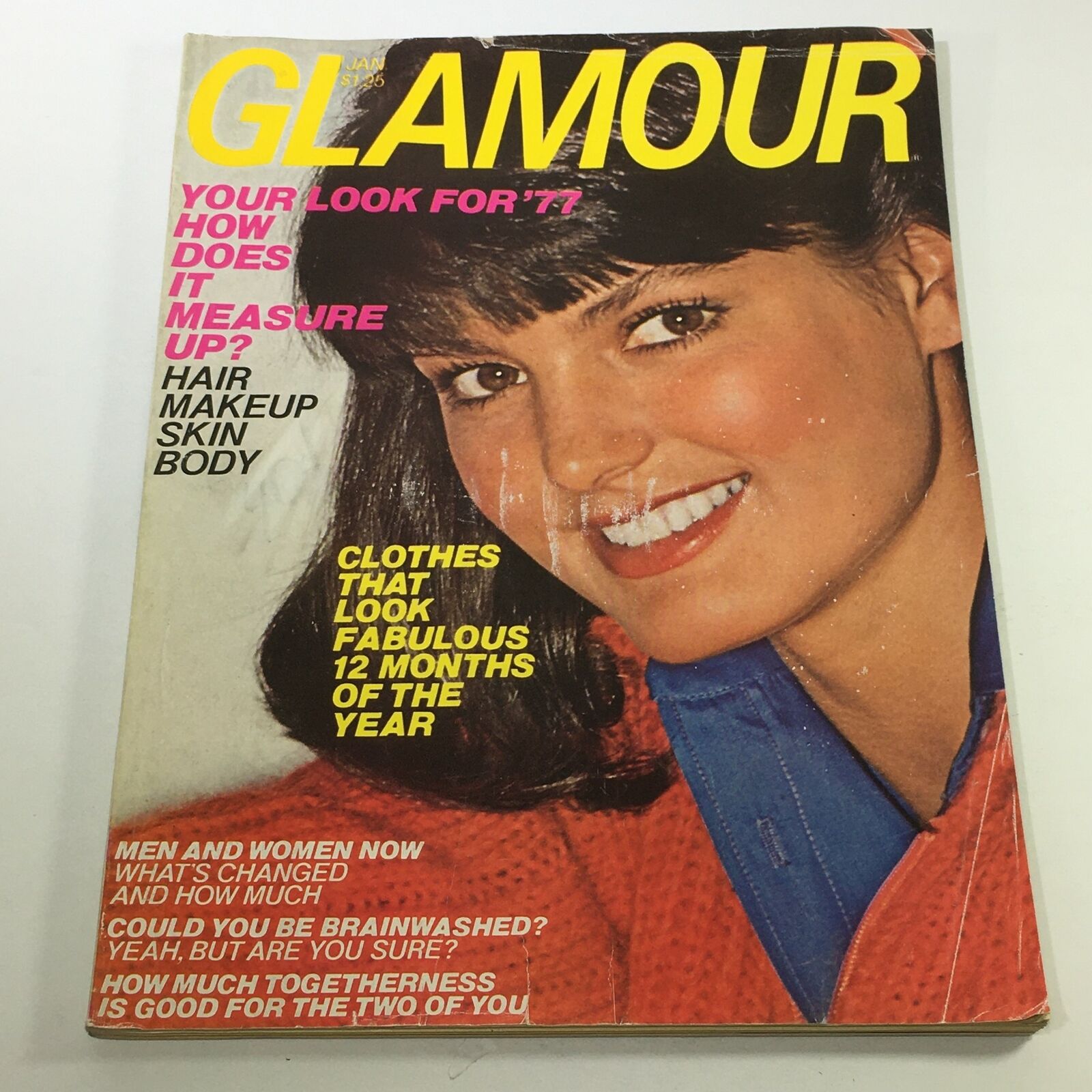 January 1977 issue of VTG Glamour Magazine featuring a close-up of a model smiling on the cover, showcasing fashion and beauty topics relevant to the 1970s era.