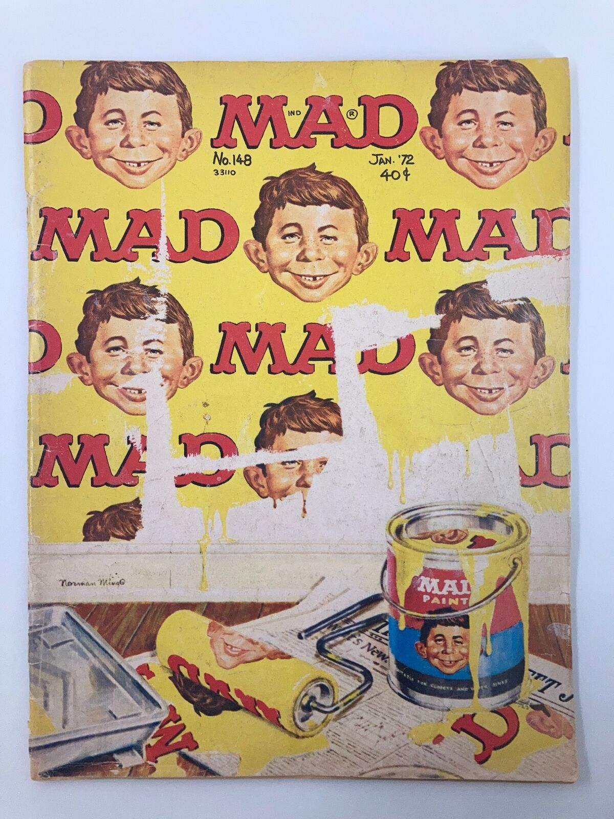 Cover of Mad Magazine January 1972 No. 148 featuring Alfred E. Neuman with a backdrop of yellow paint and humorously painted walls. The illustration depicts various expressions of Neuman, highlighting the magazine's signature satirical style.