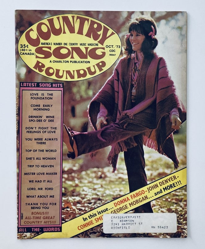 Cover of VTG Country Song Roundup Magazine October 1973 featuring Donna Fargo and John Denver, showcasing a vibrant woman in vintage attire and a colorful magazine design.