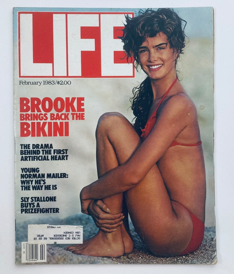 Cover of Life Magazine February 1983 Vol 6 No. 2 featuring Brooke Shields in a red bikini, highlighting the theme 'Brooke Brings Back the Bikini'. The cover showcases a vintage aesthetic, perfect for collectors of pop culture memorabilia.
