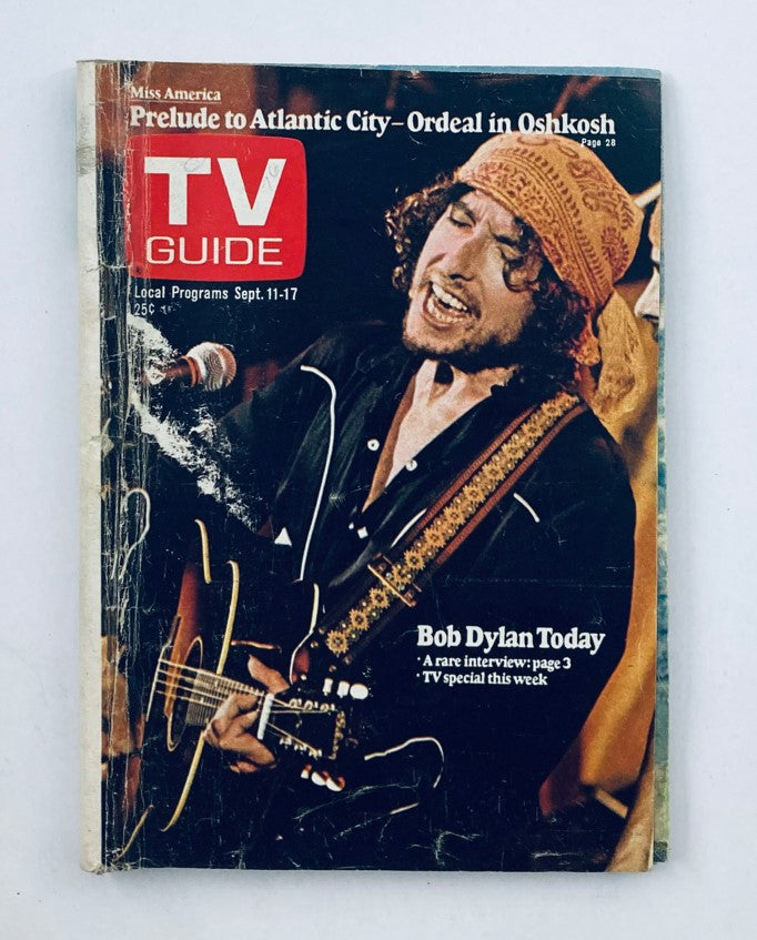 TV Guide Magazine September 11 1976, Issue #1224 featuring Bob Dylan on the cover, showcasing his performance with a guitar and wearing a distinctive headband.
