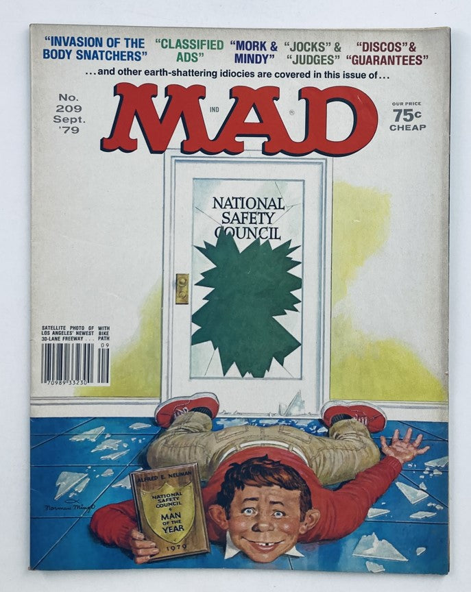 Cover of Mad Magazine September 1979 No. 209 featuring the National Safety Council, showcasing a humorous illustration of Alfred E. Neuman laying on the floor. The magazine highlights various articles including 'Invasion of the Body Snatchers' and 'Classified Ads.'
