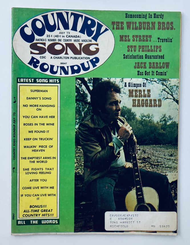 Cover of VTG Country Song Roundup Magazine July 1973 featuring a glimpse of Merle Haggard, showcasing nostalgic country music elements, magazine title on the top, and features latest song hits and articles on various artists.
