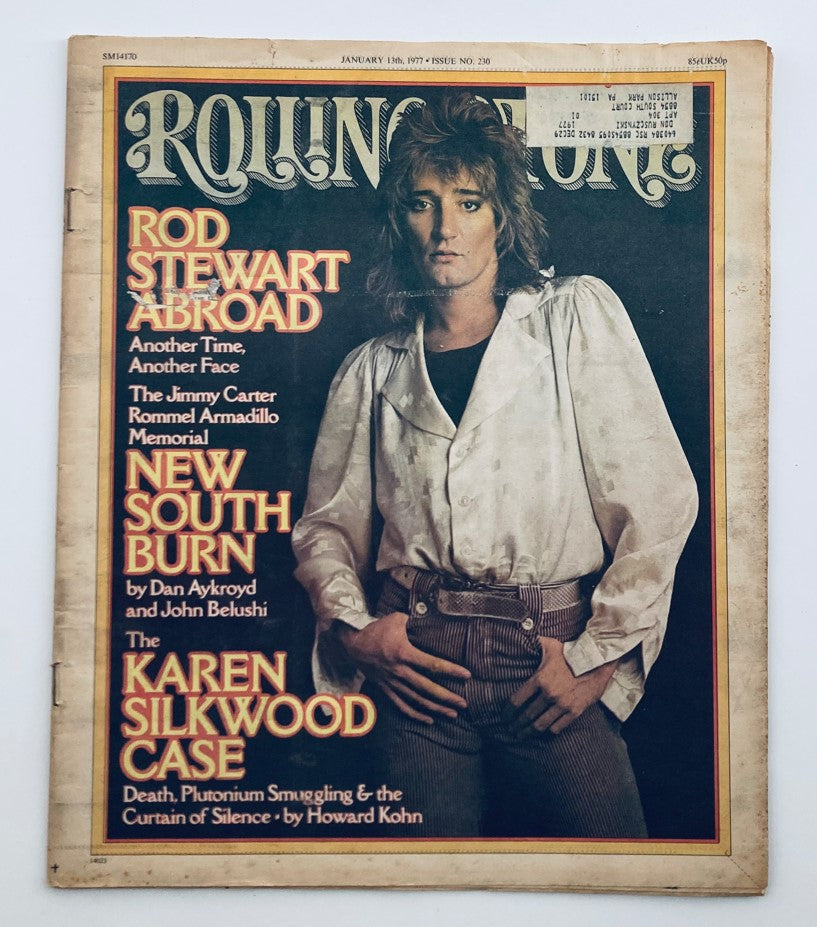 Cover of the VTG Rolling Stone Magazine January 13, 1977, issue No. 230 featuring Rod Stewart with the headline 'Rod Stewart Abroad'. The cover showcases the iconic musician styled in a white outfit, capturing the essence of the late '70s music scene.