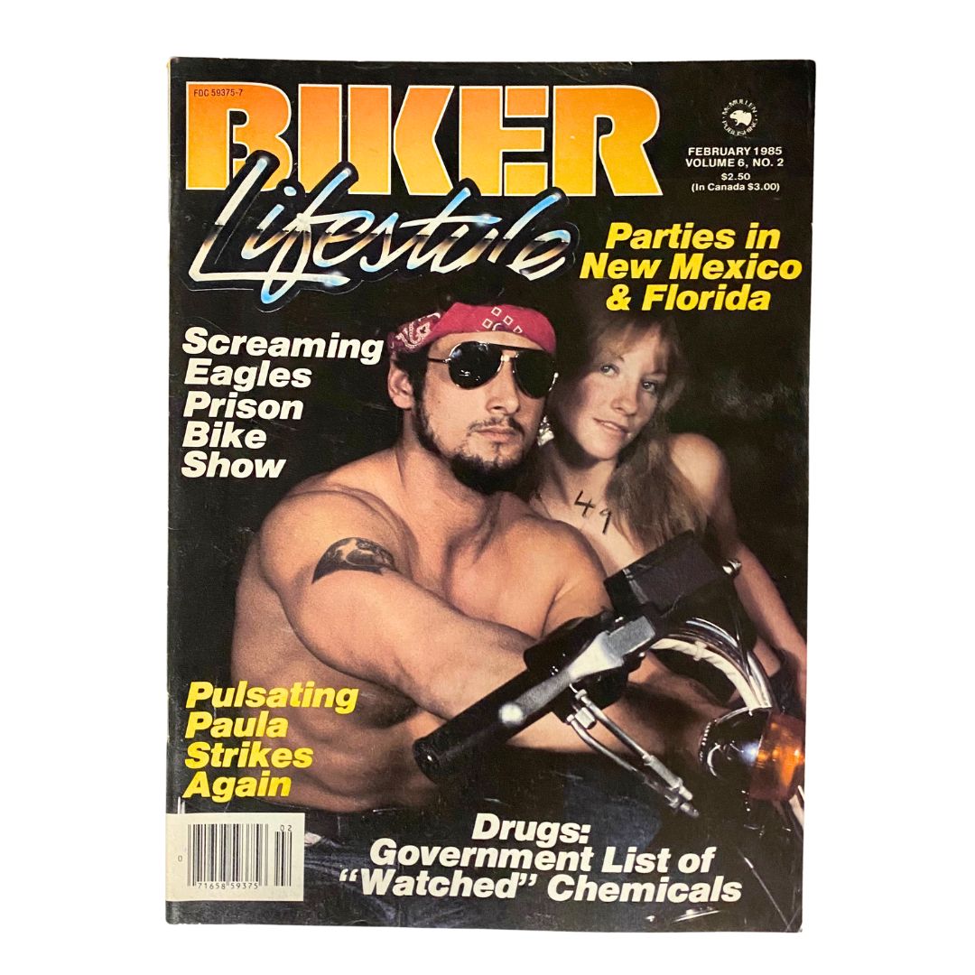 Cover of VTG Biker Lifestyle Magazine February 1985 titled 'Pulsating Paula Strikes Again,' featuring a muscular man in sunglasses holding a motorcycle, and a woman beside him, highlighting topics like 'Screaming Eagles Prison Bike Show' and 'Parties in New Mexico & Florida'.