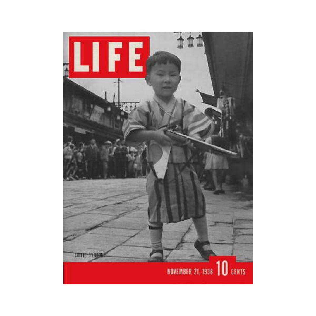 Cover of VTG Life Magazine from November 21, 1938, featuring a Japanese boy holding a gun, showcasing a unique moment in history.