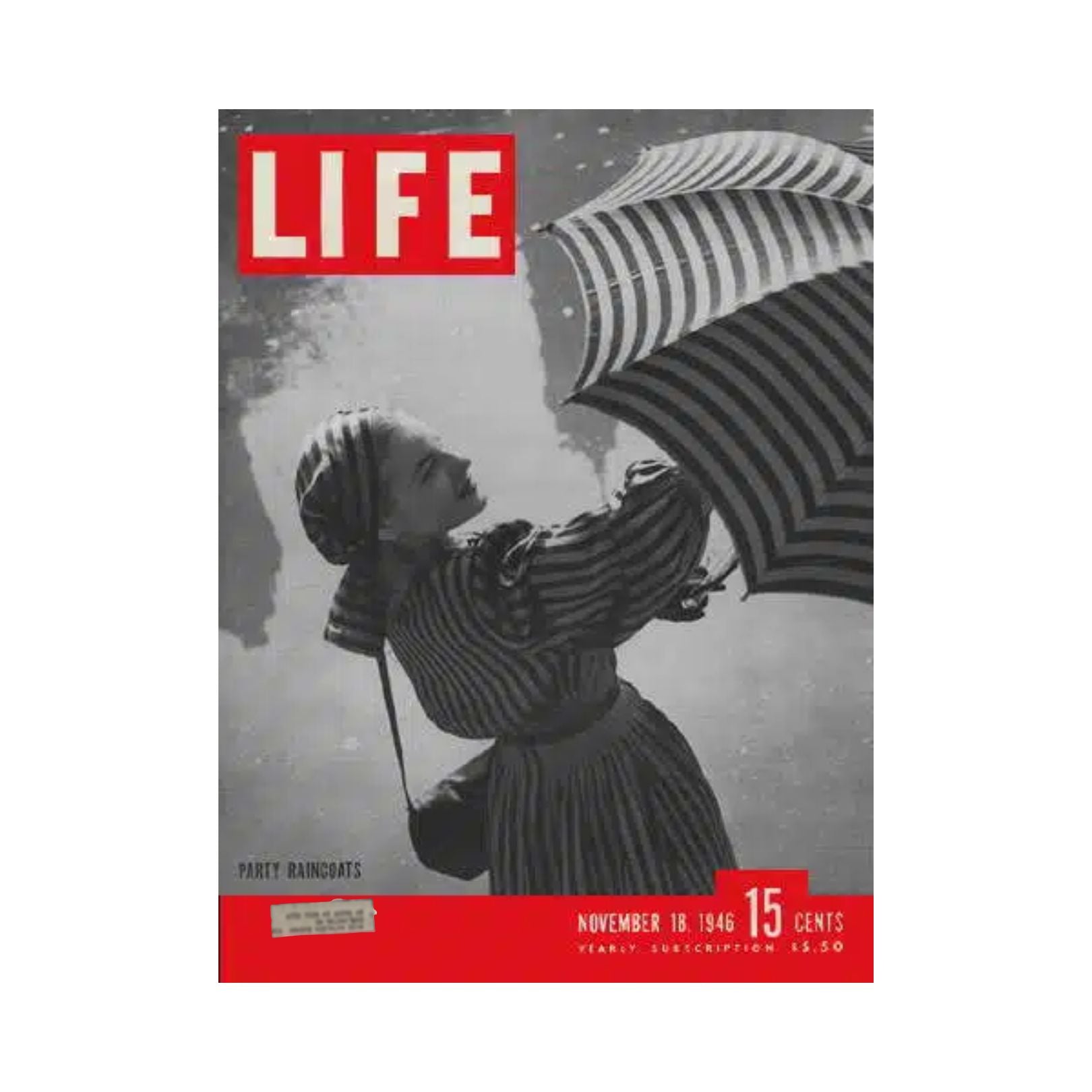 Cover of VTG Life Magazine from November 18, 1946, featuring a woman in a striped party raincoat holding an umbrella, highlighting 1940s fashion.