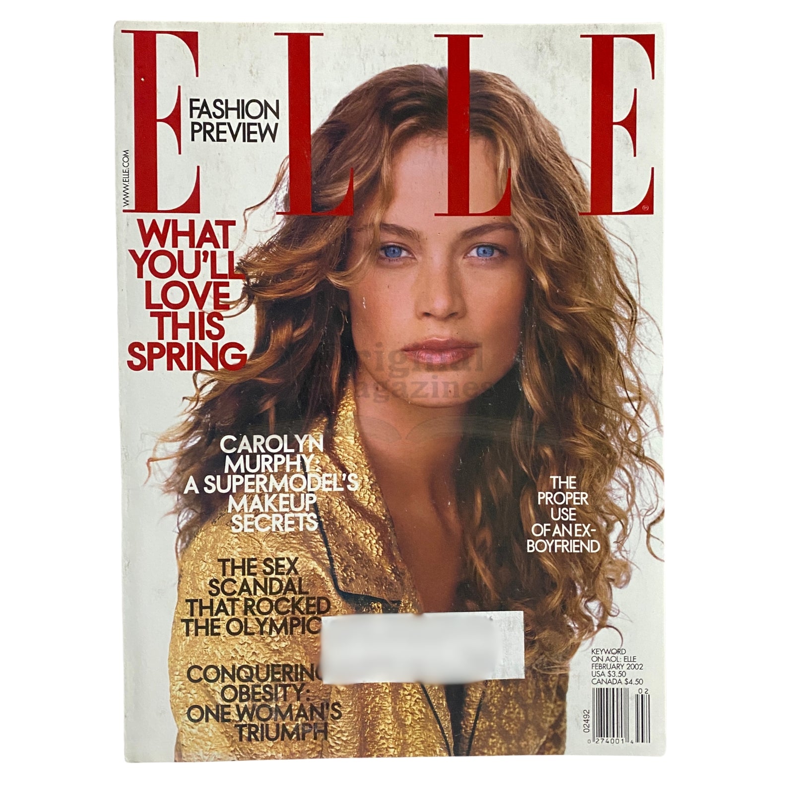 Elle Magazine February 2002 featuring Carolyn Murphy on the cover, showcasing a fashion preview with vibrant spring styles.