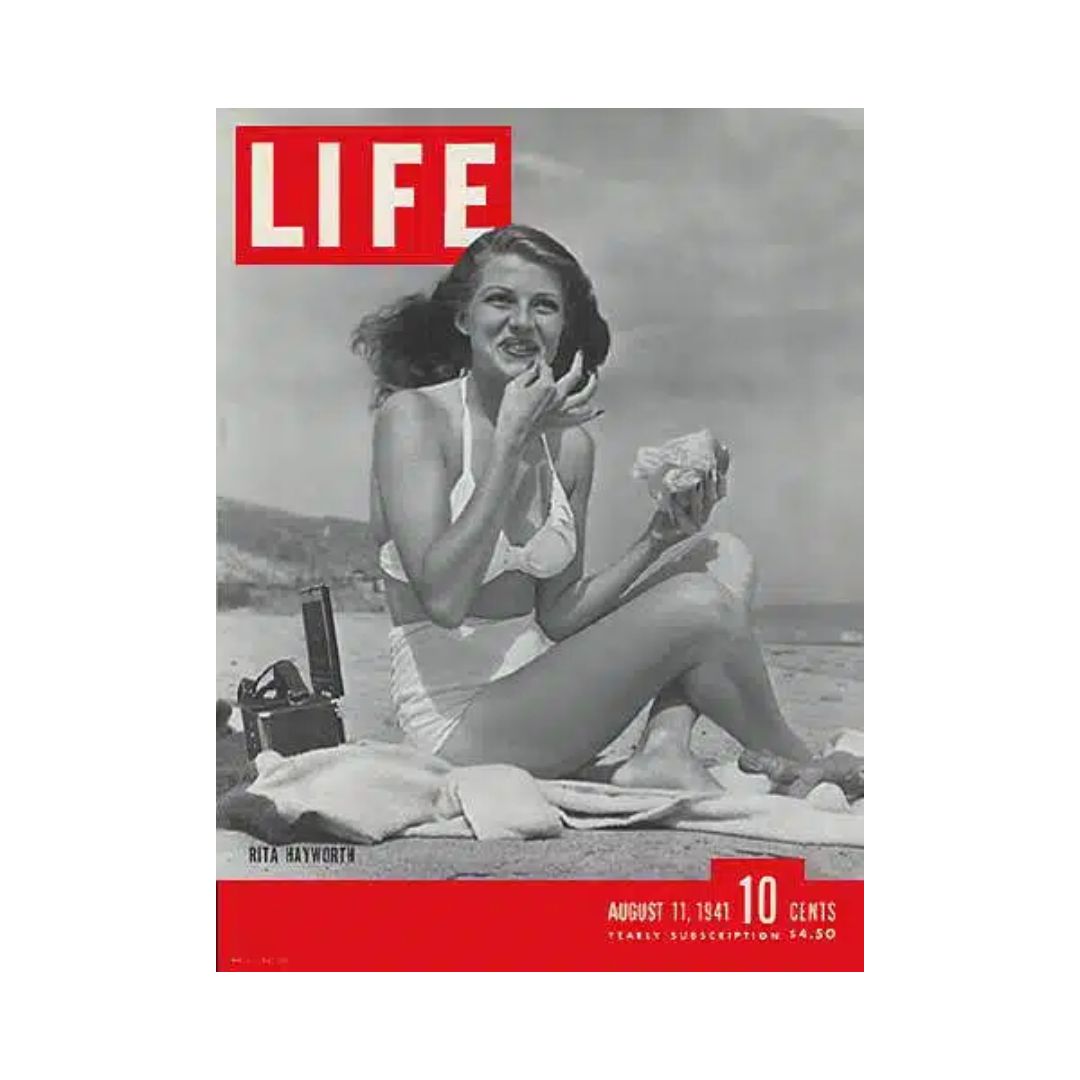 Cover of VTG Life Magazine from August 11, 1941 featuring Rita Hayworth enjoying a snack at the beach, capturing Hollywood glamour.