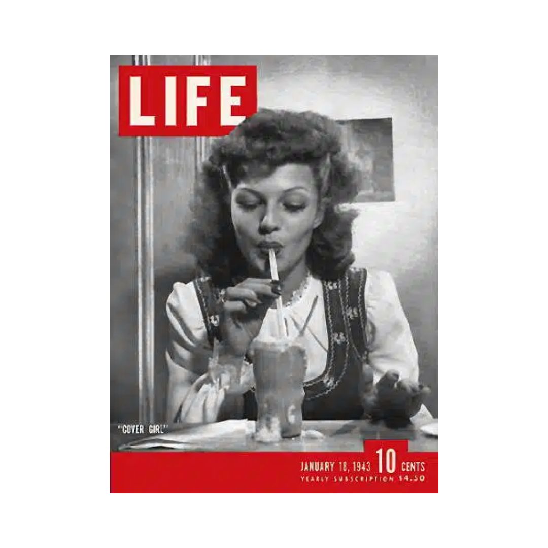 Rita Hayworth on the cover of Life Magazine, January 18, 1943, depicting a vintage scene with the actress enjoying a milkshake, and the title prominently displayed. This issue showcases the glamour of Hollywood during the World War II era, making it a significant collector's item.