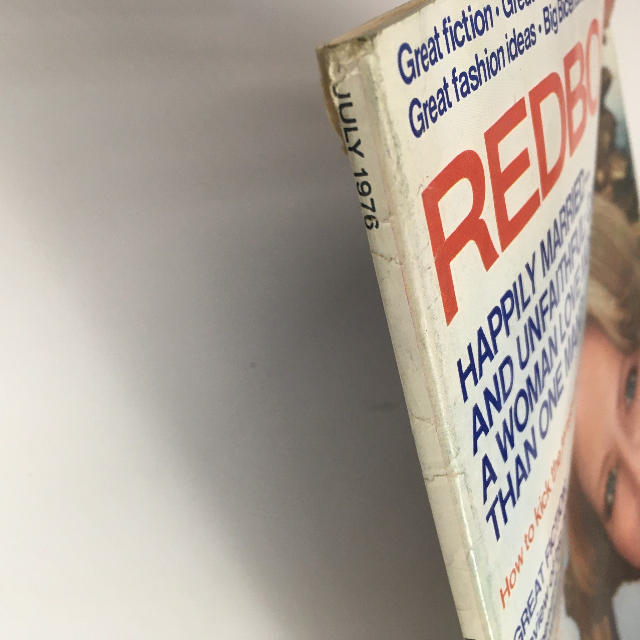 Side view of Redbook Magazine July 1976 featuring Judith Viorst's article on marriage and Alan Alda's feature, showing the magazine's spine with publication date and title highlighted.