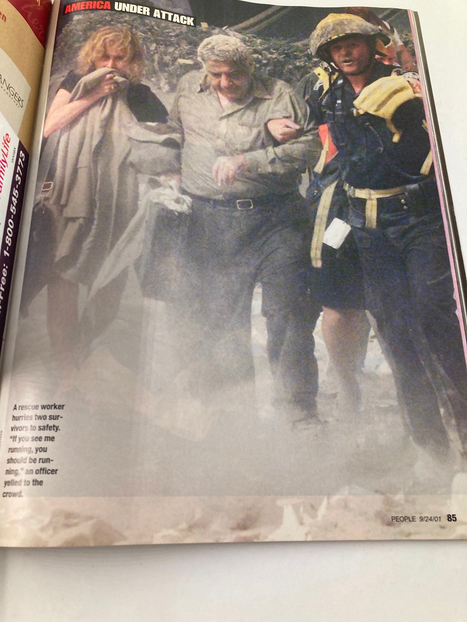 People Weekly Magazine September 24 2001 - A rescue worker assisting two survivors towards safety amidst the chaos of the 9/11 aftermath.