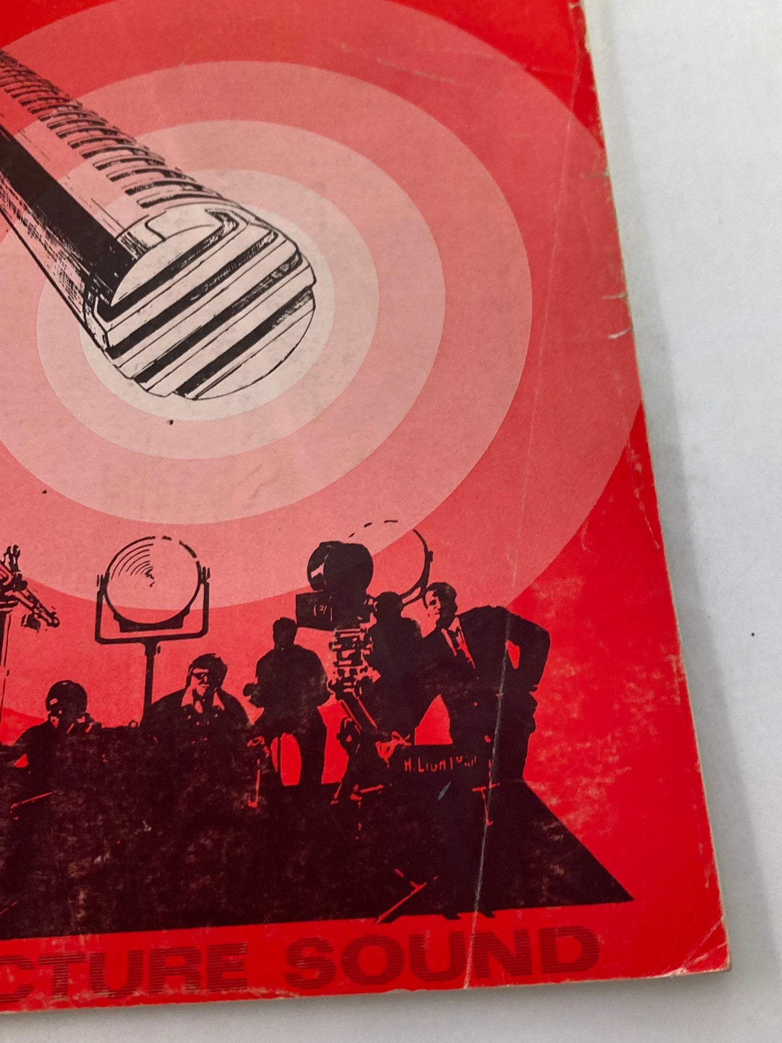 Close-up view of the cover design from American Cinematographer Magazine, April 1971, showcasing a microphone illustration and concentric circles symbolizing sound in film.