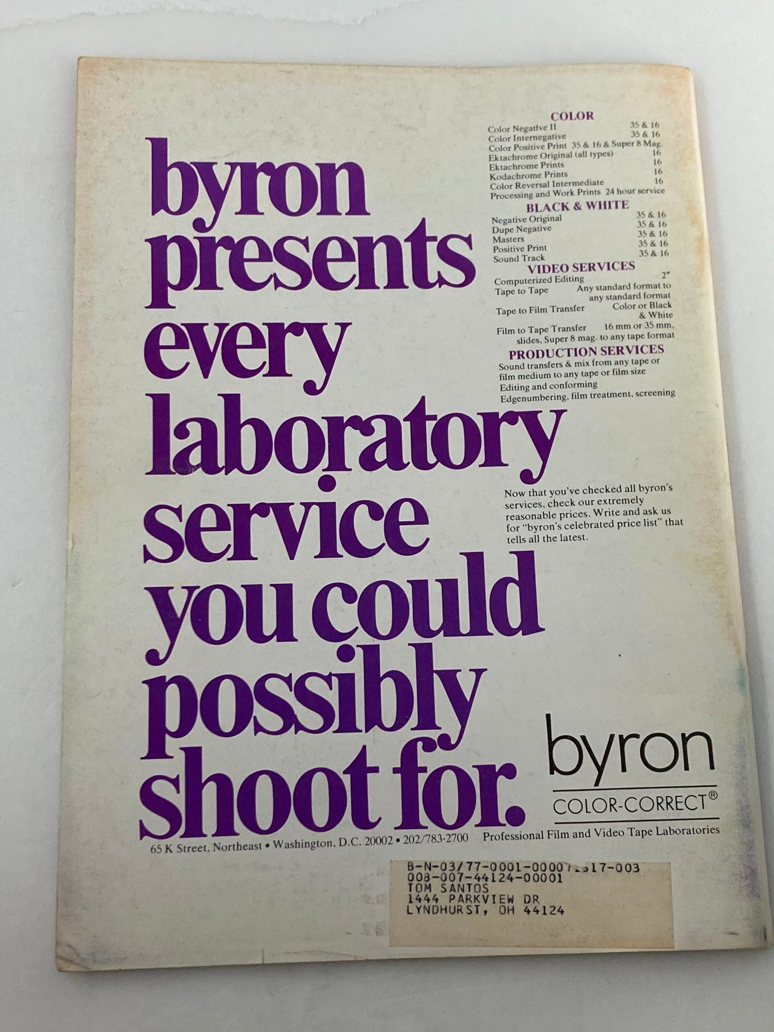 Back cover of American Cinematographer Magazine December 1976, showcasing byron's laboratory services in bold purple text against a pale background, highlighting film and video production offerings.