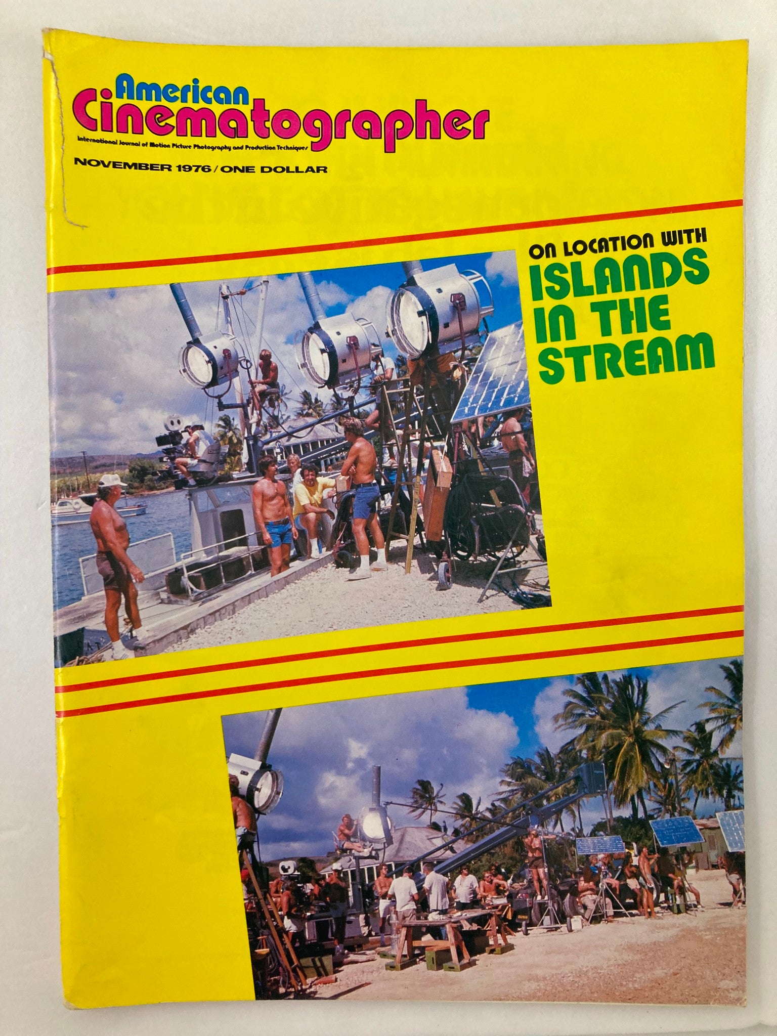 Cover of American Cinematographer Magazine from November 1976 featuring the title 'On Location with Islands in the Stream', showcasing a colorful photograph of a film crew at work on location, surrounded by film equipment under a tropical sky.