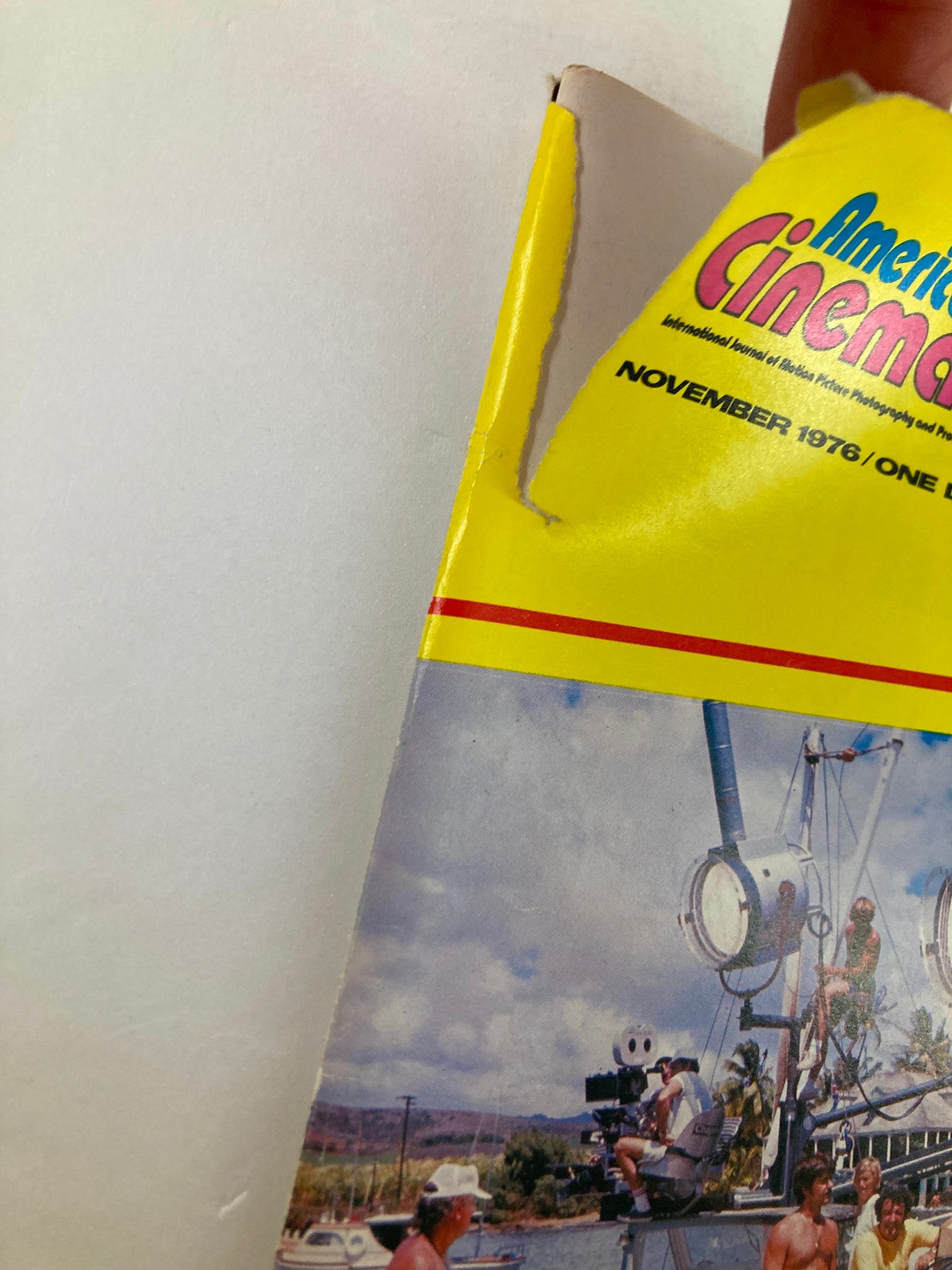 Close-up of the damaged corner of the American Cinematographer magazine from November 1976, featuring 'Islands in the Stream' by Hemingway.