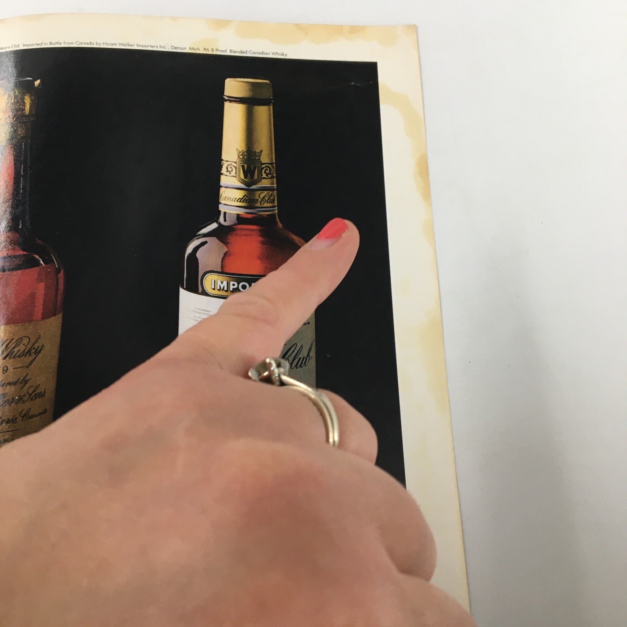 Image of a vintage Gourmet Magazine from October 1981, showcasing a hand pointing at a bottle of blended Canadian whisky, highlighting the rich culinary trends discussed in the issue.