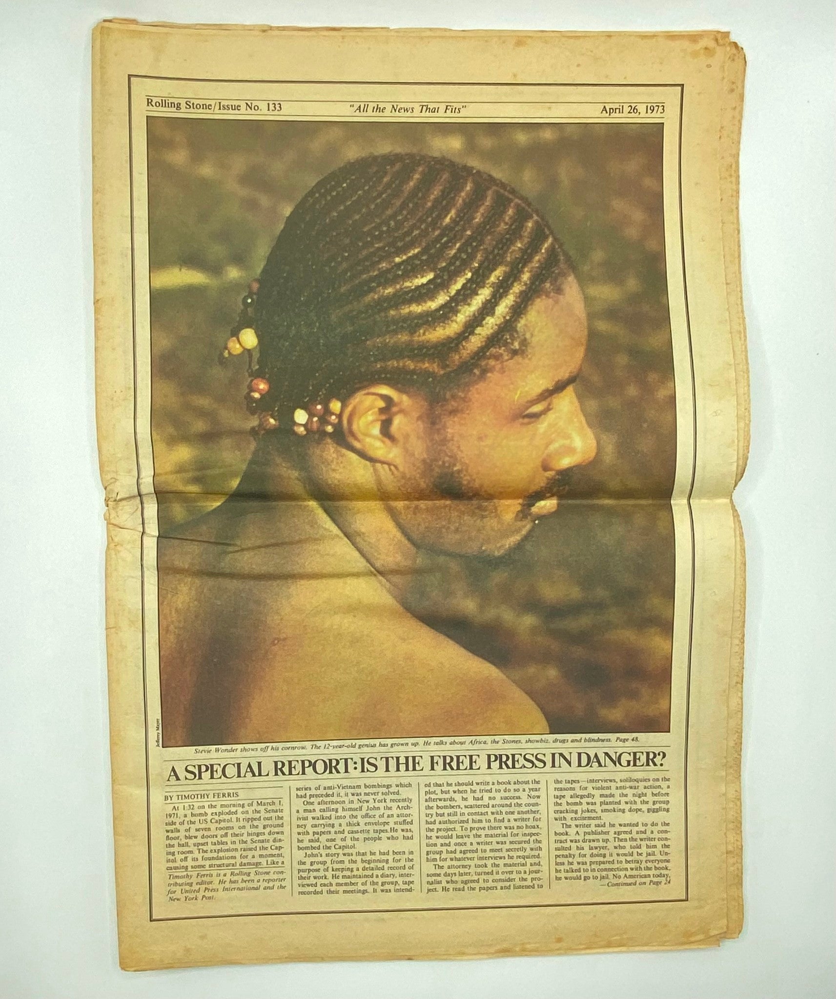 Inside page of Rolling Stone Magazine, April 26, 1973, Issue No. 133 featuring a photograph of a man with braided hair, along with a discussion on freedom of the press, highlighting the journalistic themes of the era.