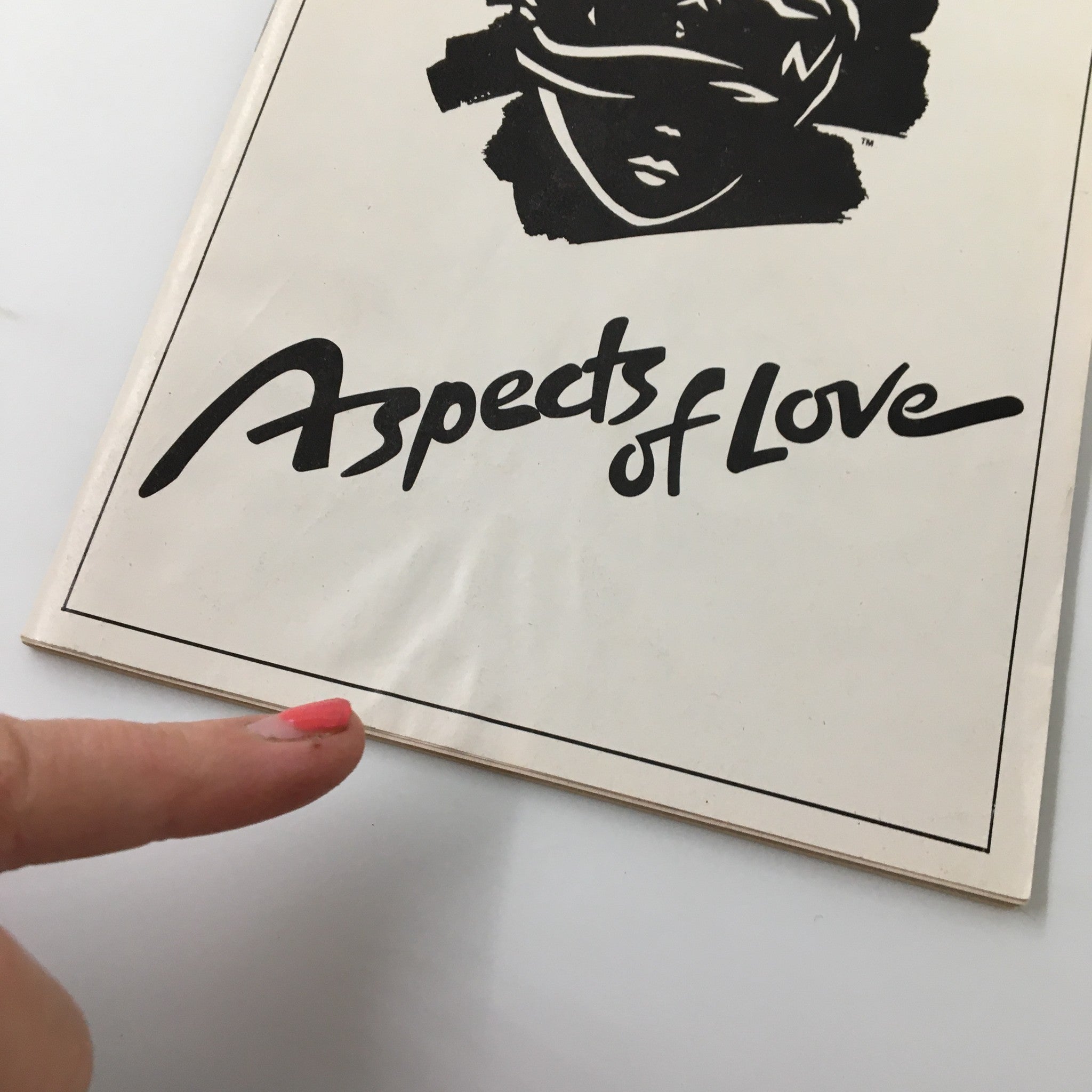 Close-up of the 1990 Playbill for Aspects of Love, highlighting details and wear on the cover.