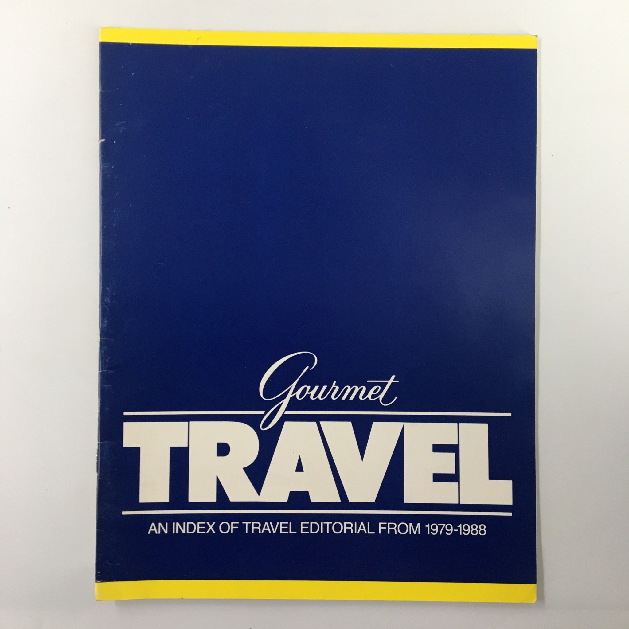 Cover of Gourmet Travel Magazine An Index of Travel Editorial From 1979-1988 featuring a blue background with bold white typography.