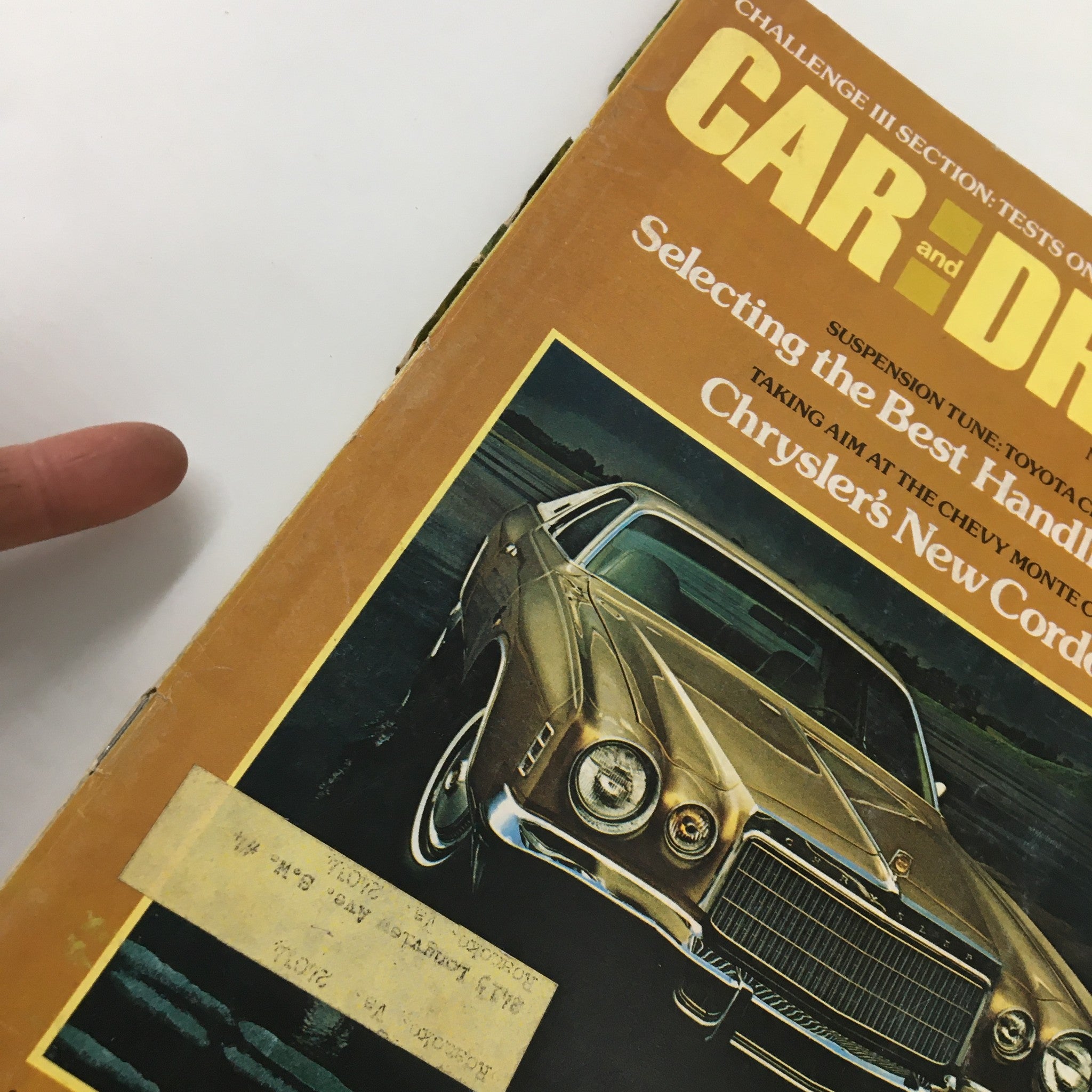 Close-up of the cover of VTG Car and Driver Magazine, November 1974, highlighting the text 'Selecting the Best Handling Package' and a vintage gold vehicle.
