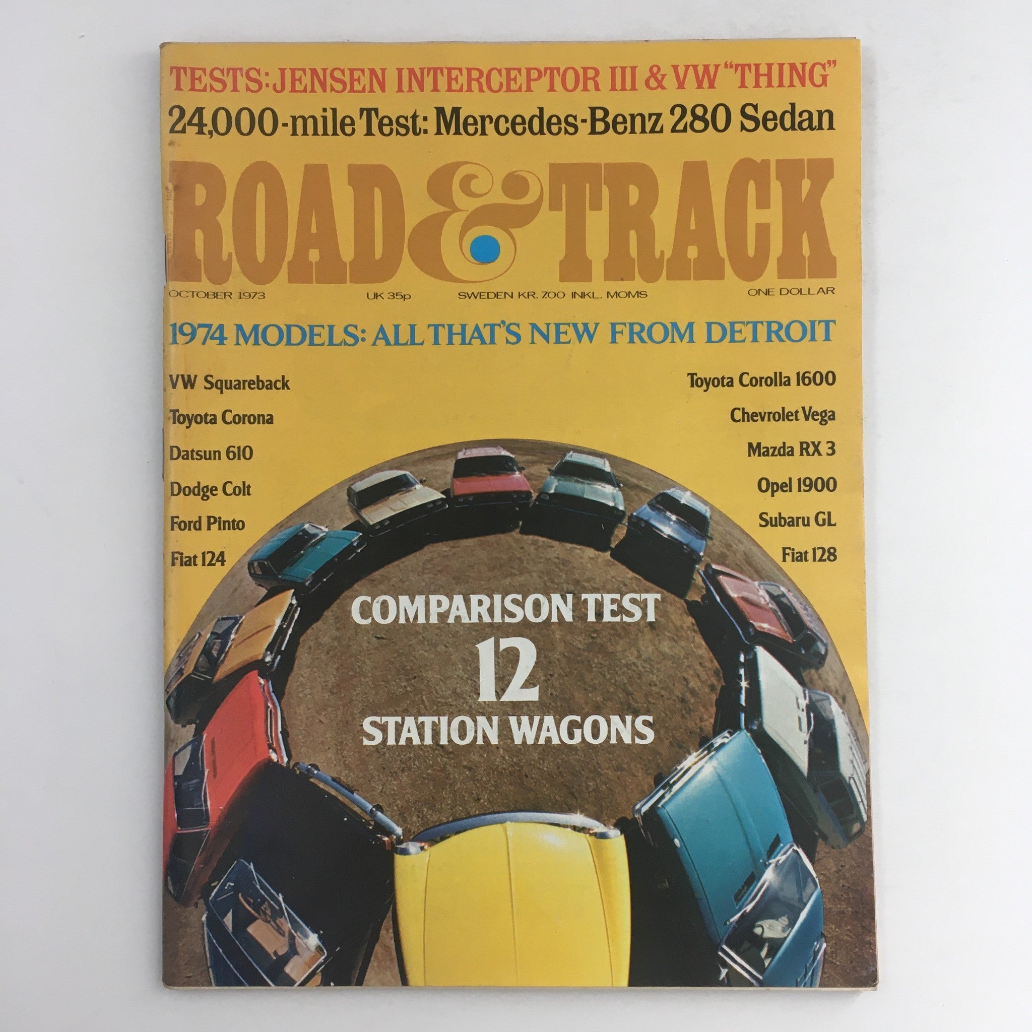 October 1973 cover of Road & Track Magazine featuring the Mercedes-Benz 280 Sedan test. Vibrant design with colorful cars in a circular layout, including models such as VW Squareback, Toyota Corona, and others. This vintage magazine is in Very Good condition, no label, showcasing automotive insights from the era.