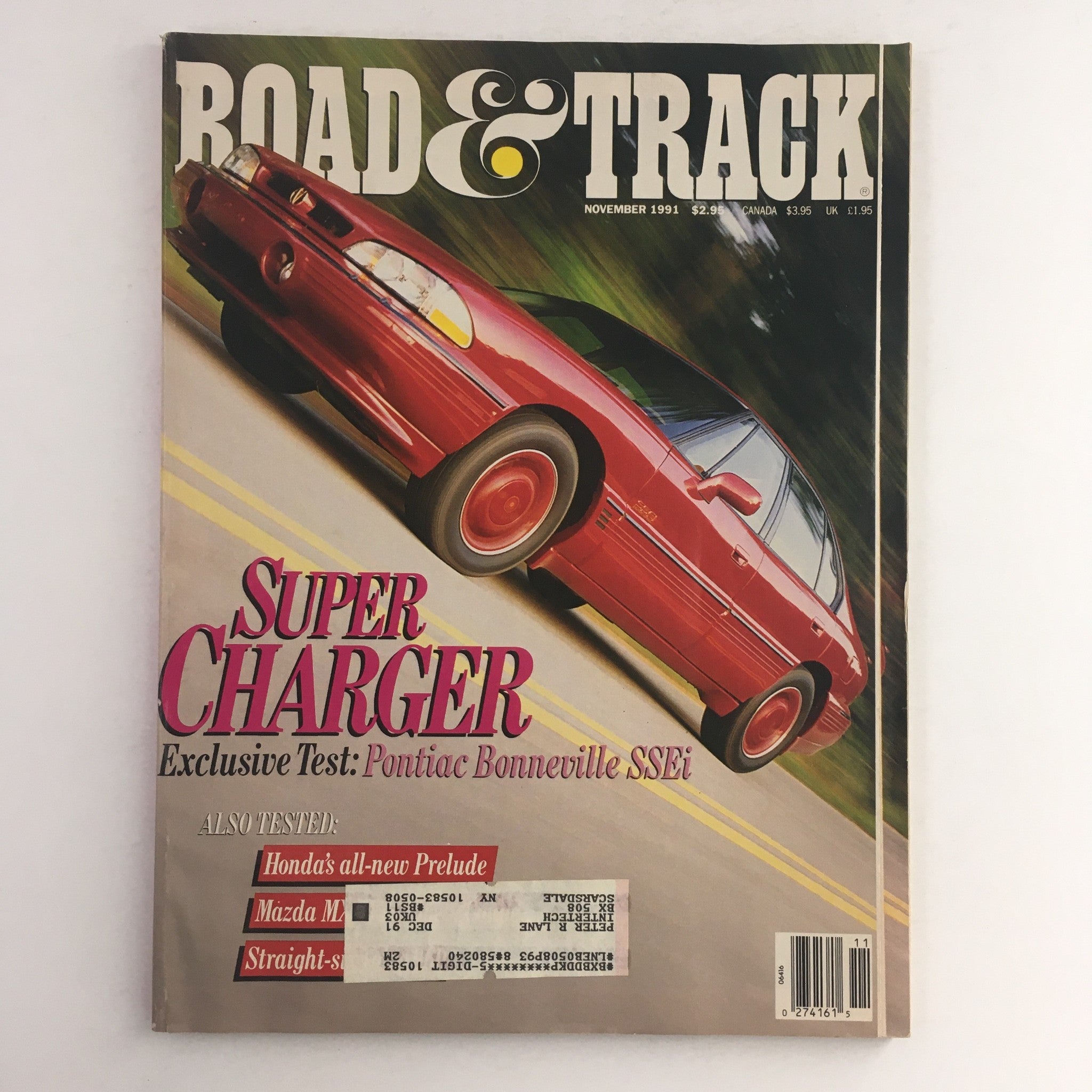 Cover of Road & Track Magazine from November 1991 featuring a Super Charger Pontiac Bonneville SSEi. The magazine displays vibrant graphics and information on car performance, highlighting exclusive tests with details on other vehicles like the Honda Prelude and Mazda M.