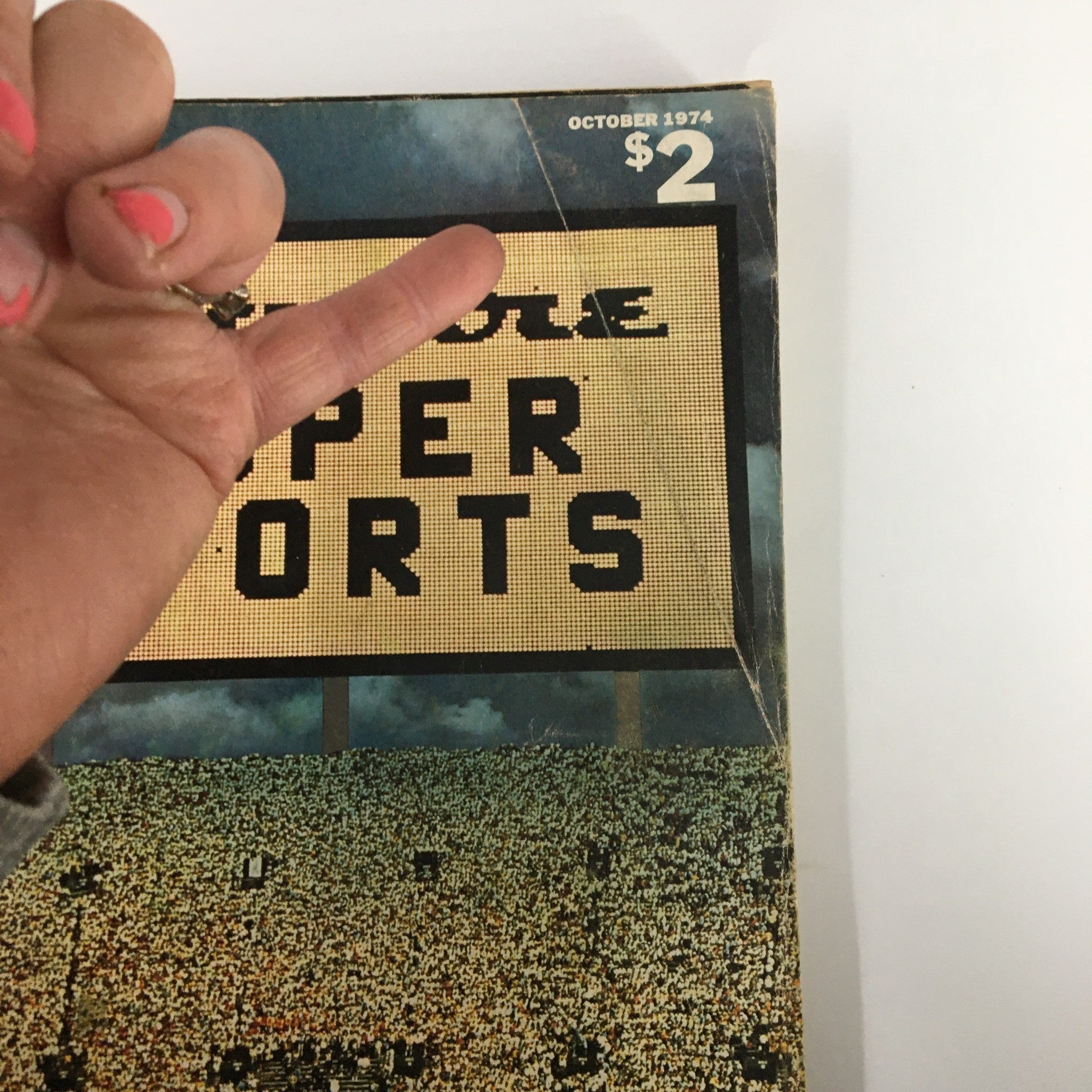 Close-up of the Esquire Magazine October 1974 cover with a hand gesturing towards the 'Super Sports' title.